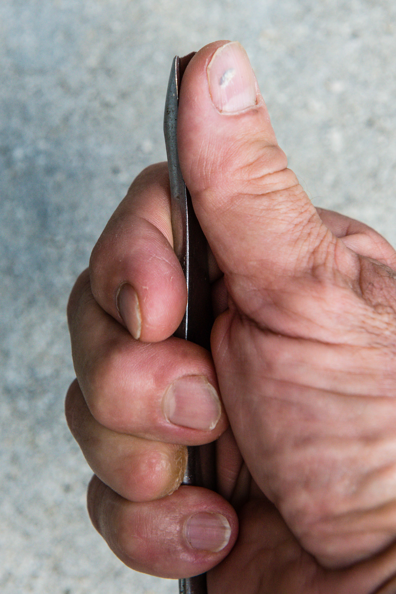 Thumb and flat elevator tip facing up, open side of fist.