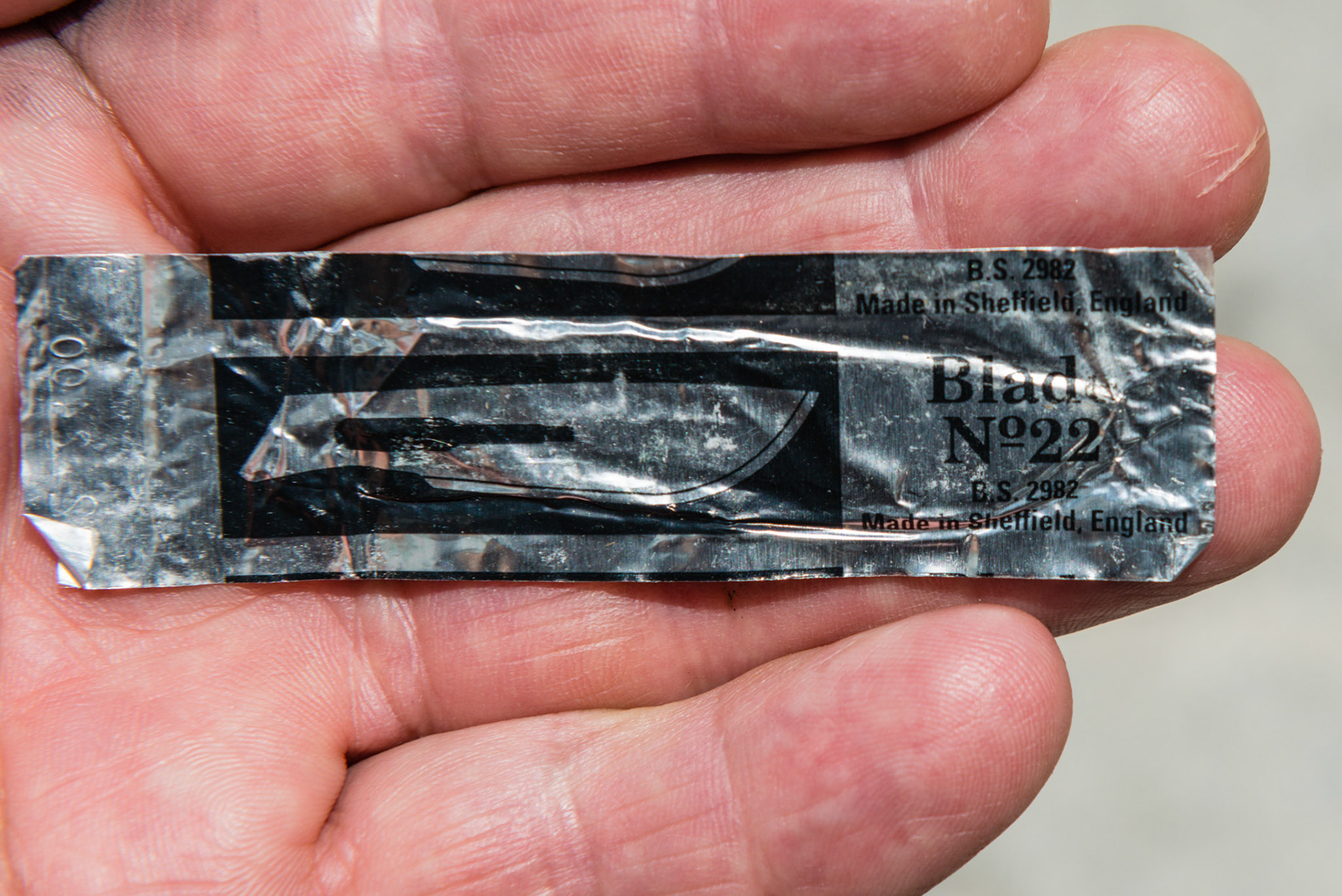 A #22 surgical blade in its wrapper.