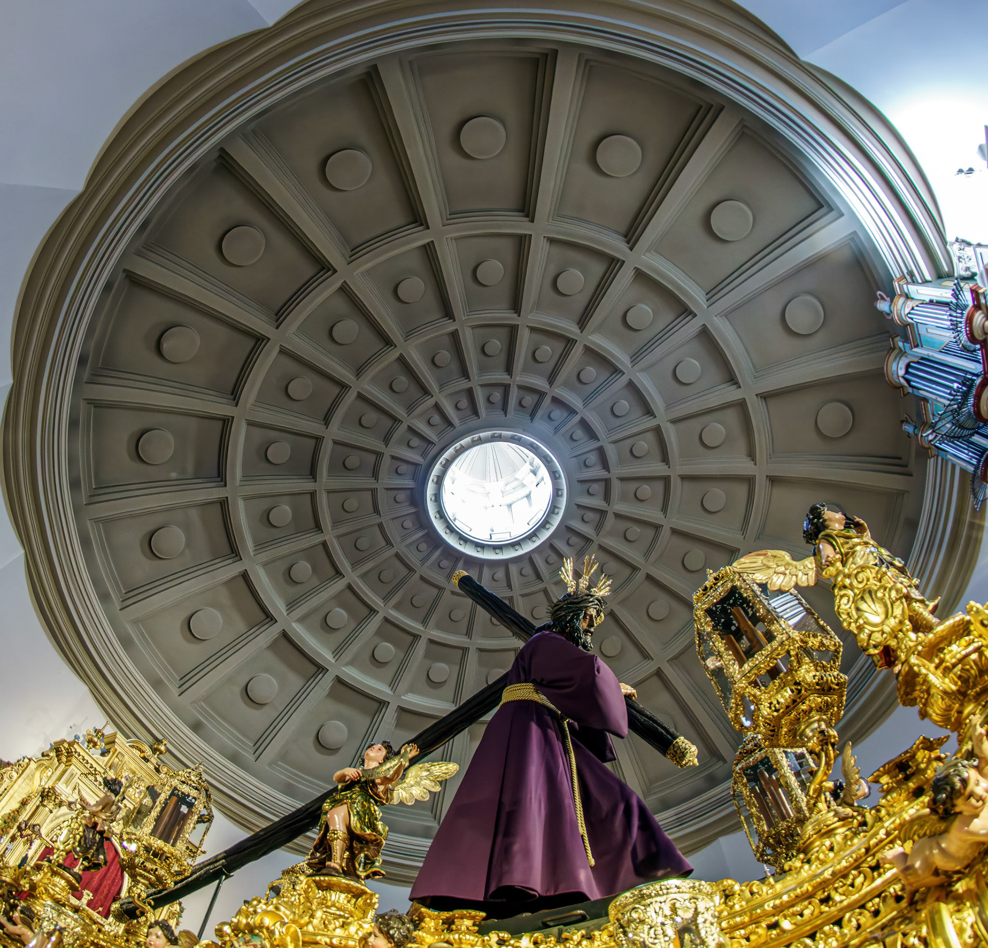 El Gran Poder on his paso moves beneath the dome of the Basilica, illustrating the solemnity and grandeur of Holy Week in Seville.