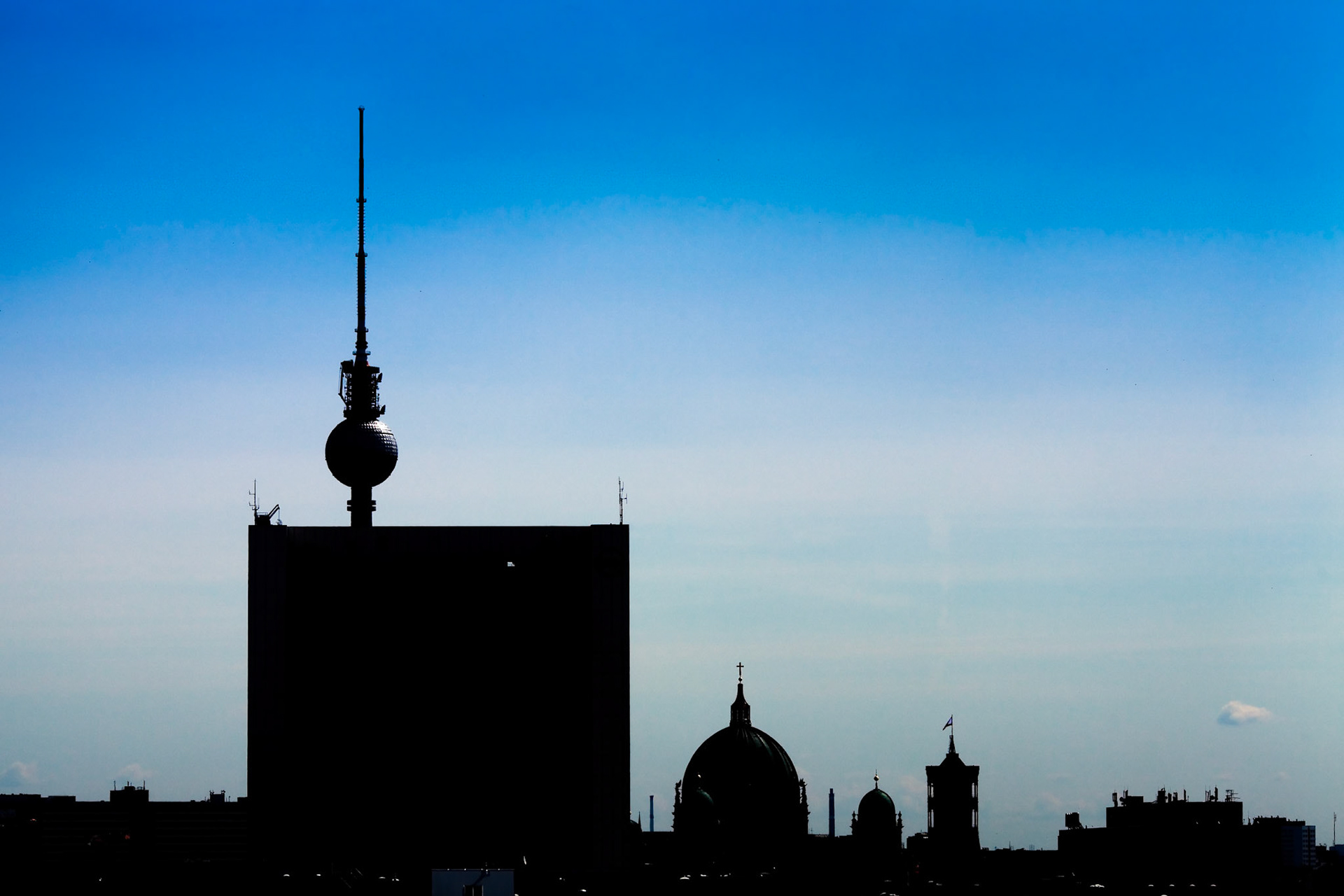 Explore the iconic Berlin skyline featuring landmarks like the Fernsehturm and Berliner Dom seen from the Reichstag terrace.