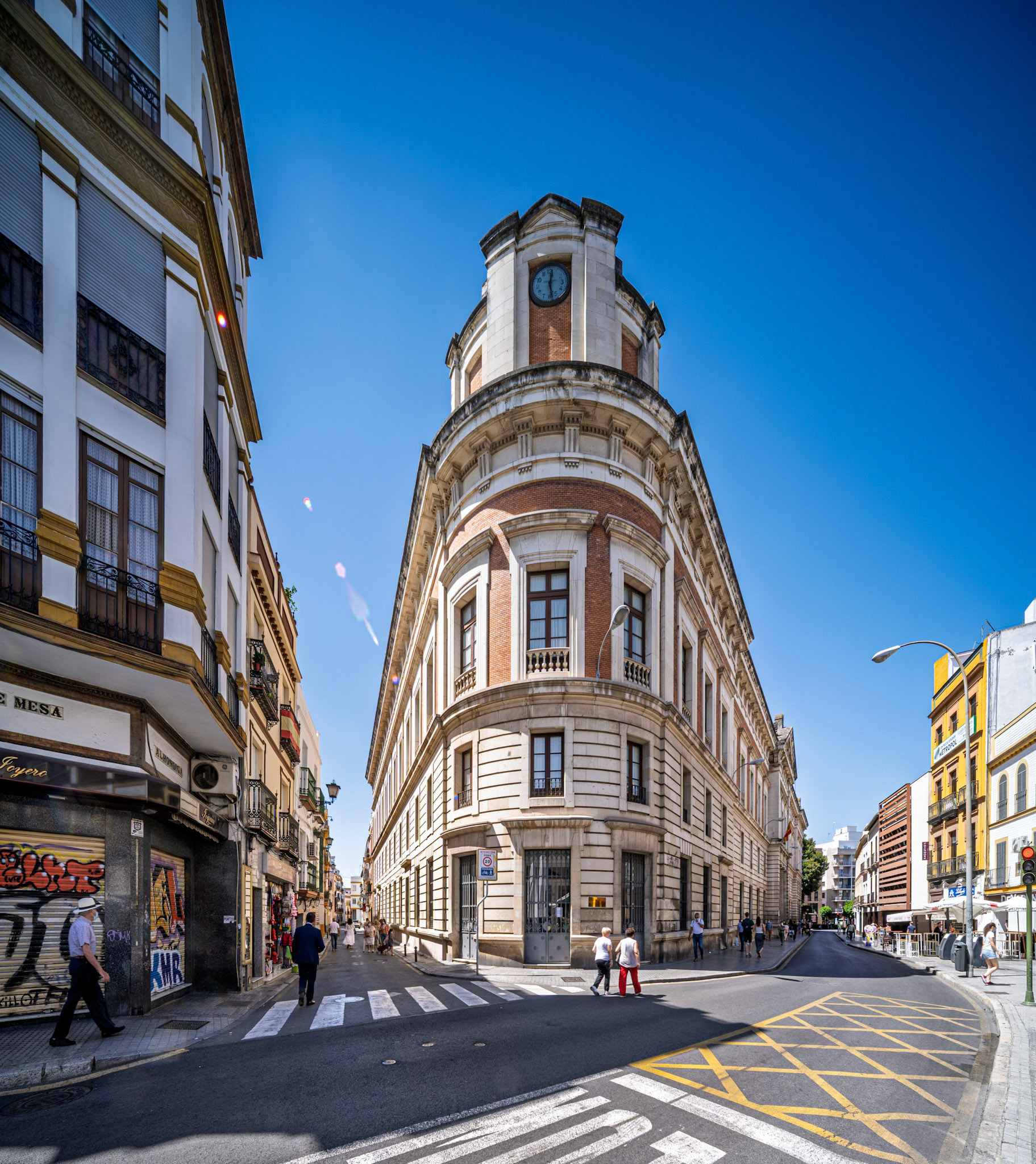 Seville, Spain, May 29 2021, A sunny day in Seville shows the neoclassical former Palace of Justice with its clocktower, located at the busy corner of Alhóndiga and Almirante Apodaca.