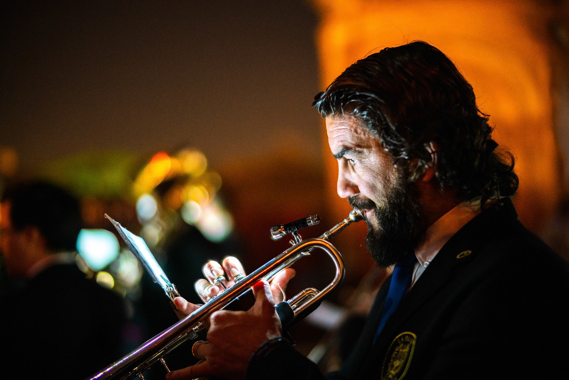 Seville, Spain, Apr 10 2017, Musician playing trumpet on a vibrant evening of Holy Week in Seville, Spain