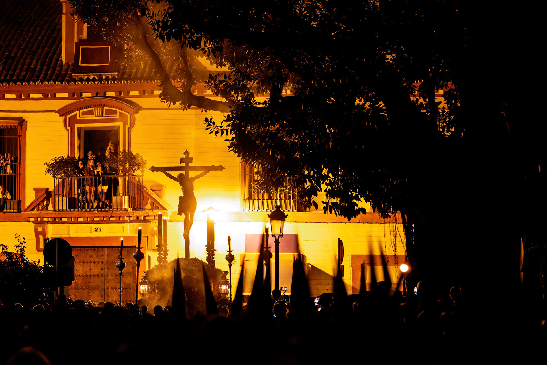 Silhouette of Christ of Burgos marching through Burgos Square on Holy Wednesday night during Holy Week in Seville, Andalusia, Spain.