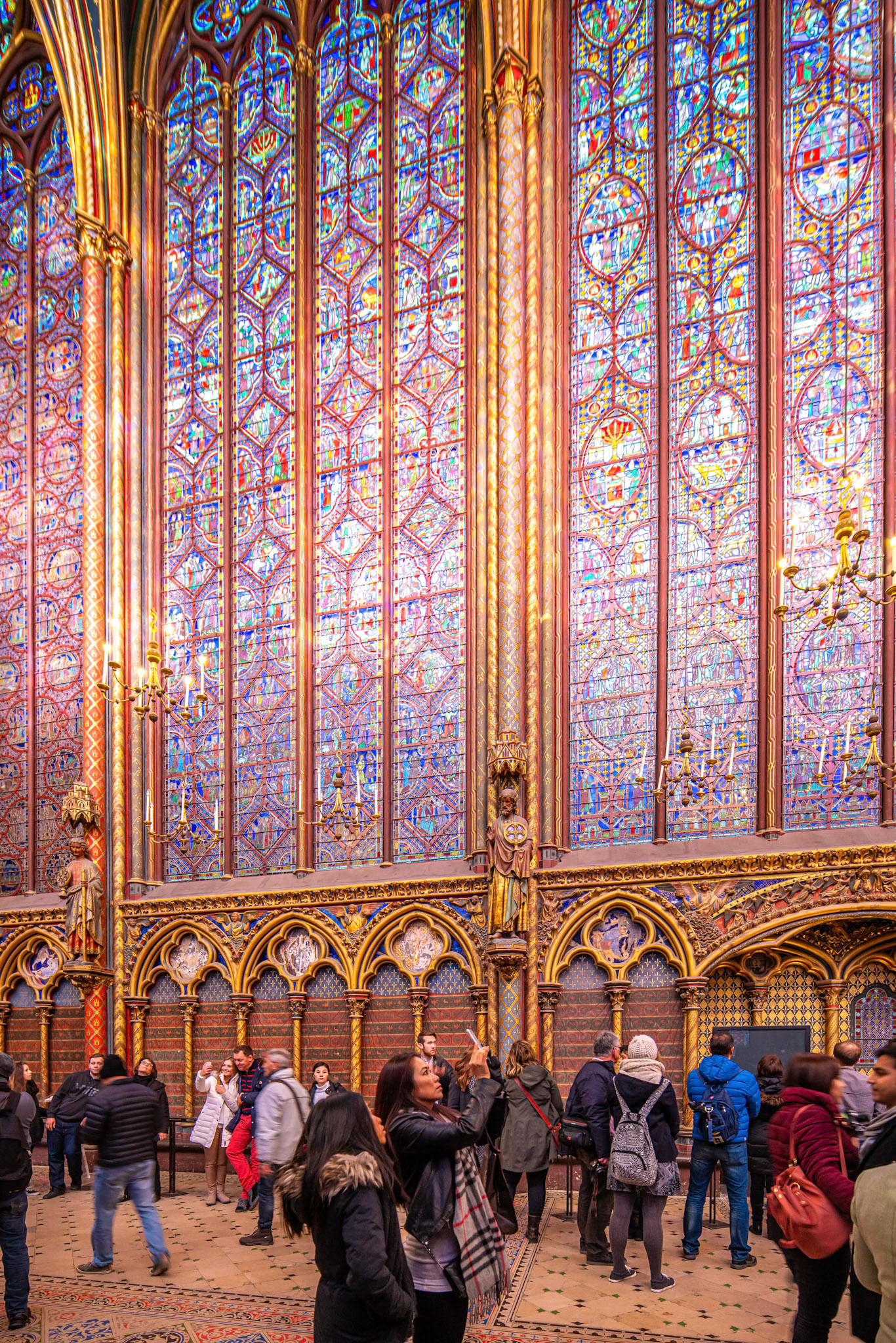 Tourists admire the stunning stained glass windows at the Sainte Chapelle.