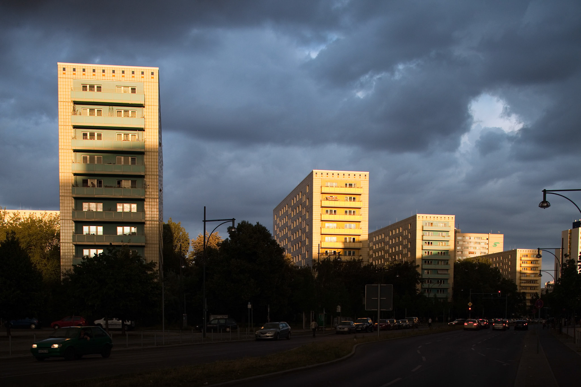 Sunset illuminates contemporary apartment buildings on Alexander Street in East Berlin, creating a striking contrast.