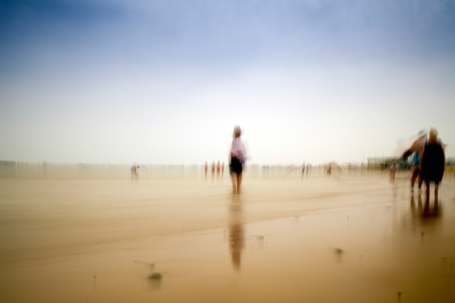 People on the beach, Sanlucar de Barrameda, Spain. Daylight long exposure shot by the use of neutral density filters.