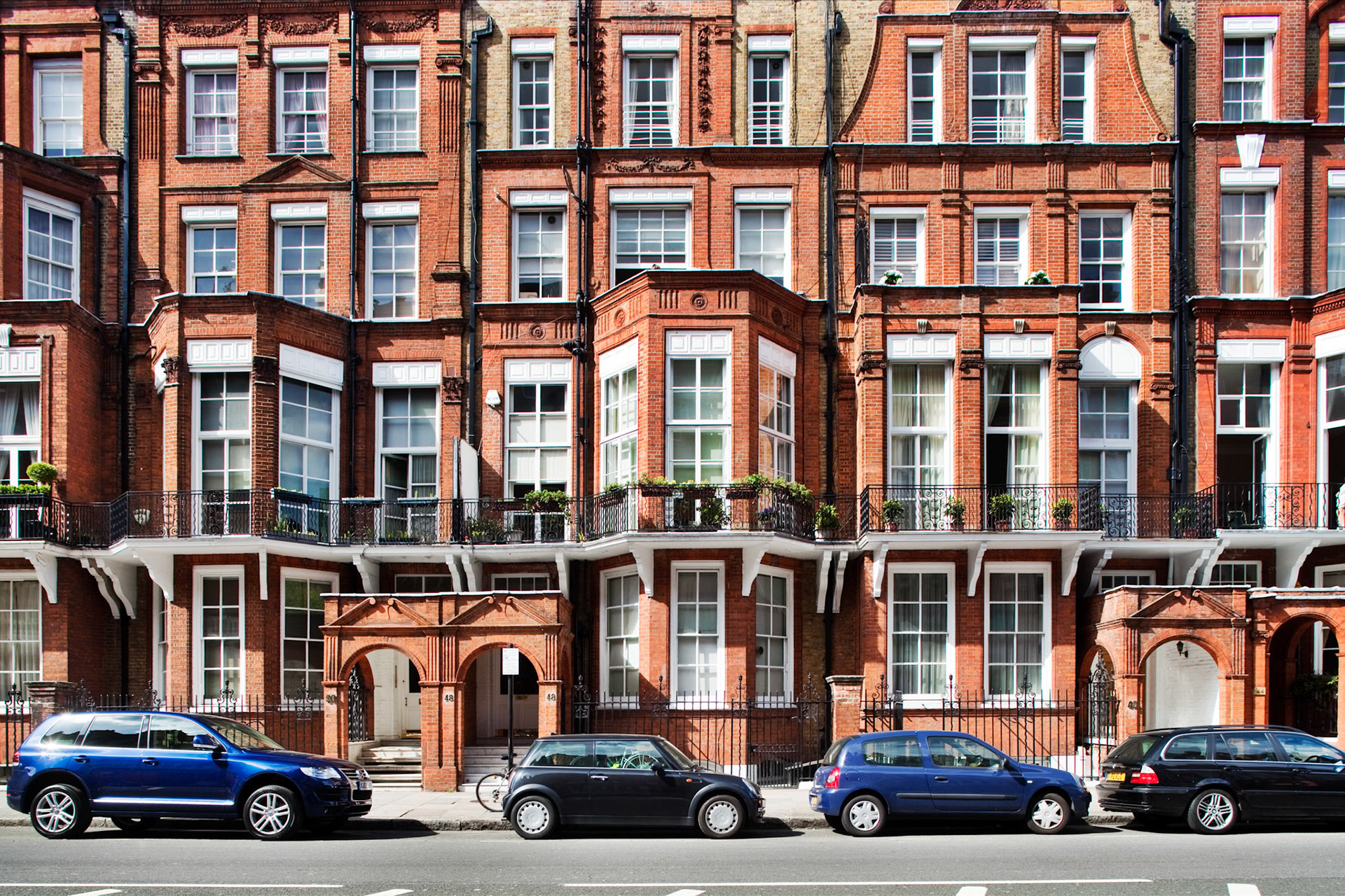 Explore the beautiful architecture of Victorian houses lining Pont Street in Kensington, showcasing their iconic red brick facades.