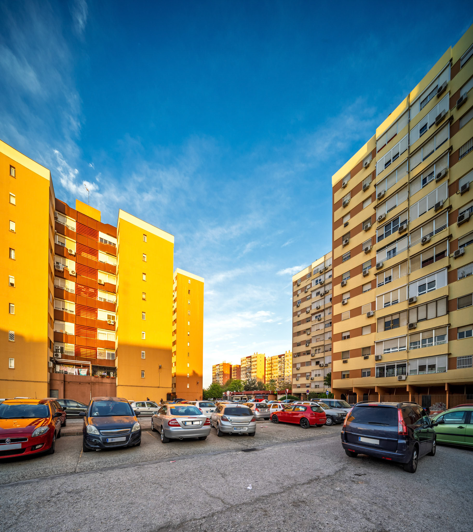 Located in Pino Montano, these symmetrical ochre and beige housing blocks reflect Seville's urban development from the late 20th century.