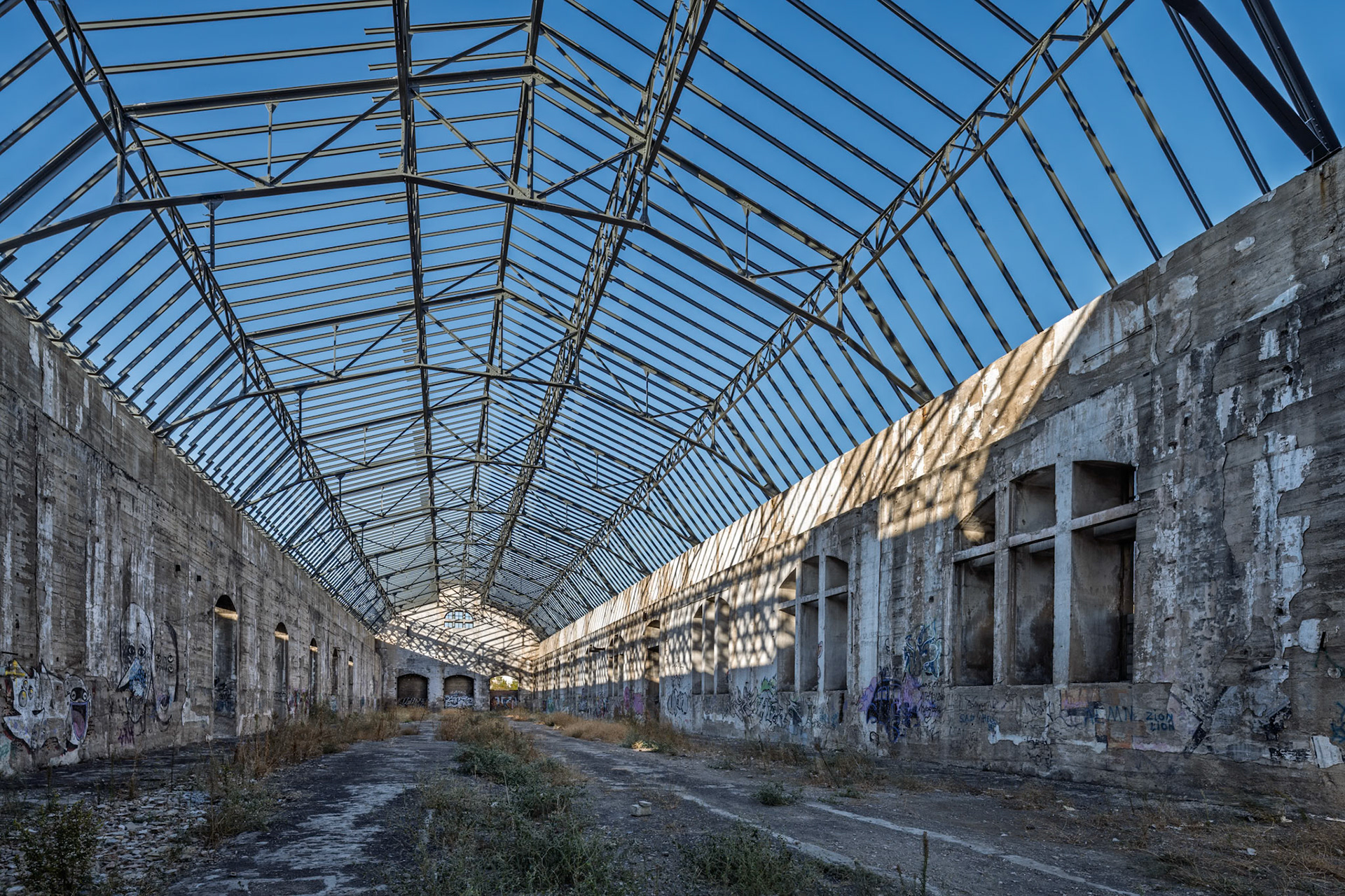 The abandoned Renfe warehouses in San Jeronimo, Seville show graffiti and decayed structures as they prepare for a new tech and innovation purpose.
