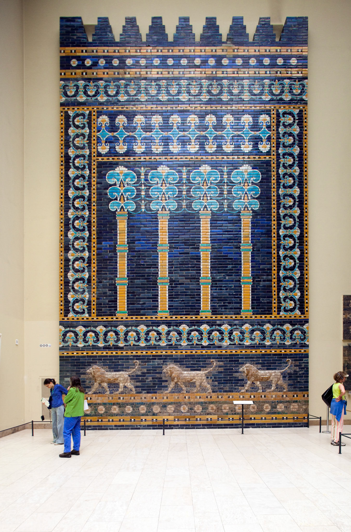 Berlin, Germany, July 24 2009, Visitors admire the intricate details of the Ishtar Gate wall at Pergamon Museum, showcasing Babylon’s ancient artistry.