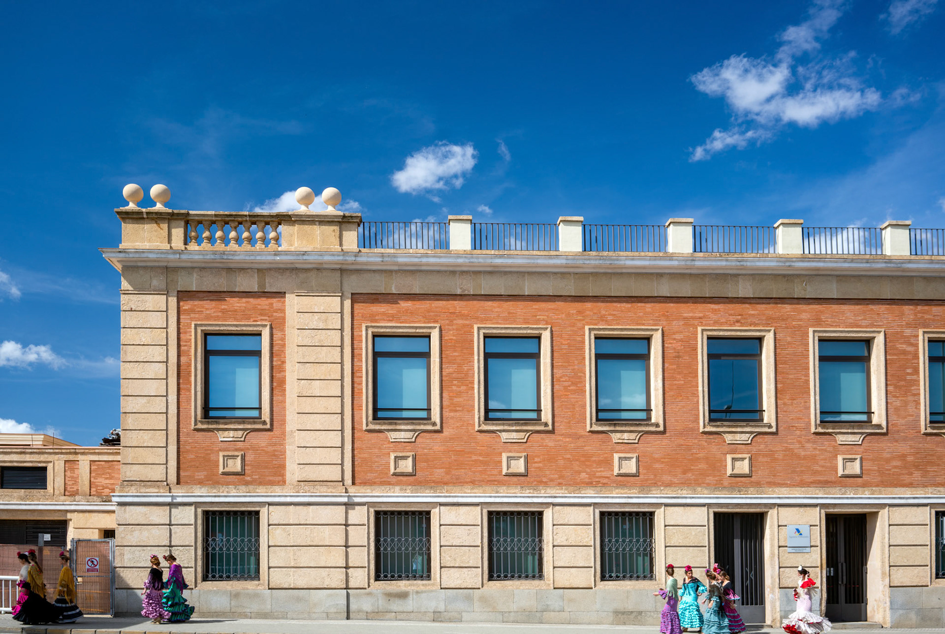 Seville, Spain, Apr 19 2018, Young women in vibrant flamenco dresses stroll towards the April Fair in Seville, capturing the festive spirit of Andalusia.