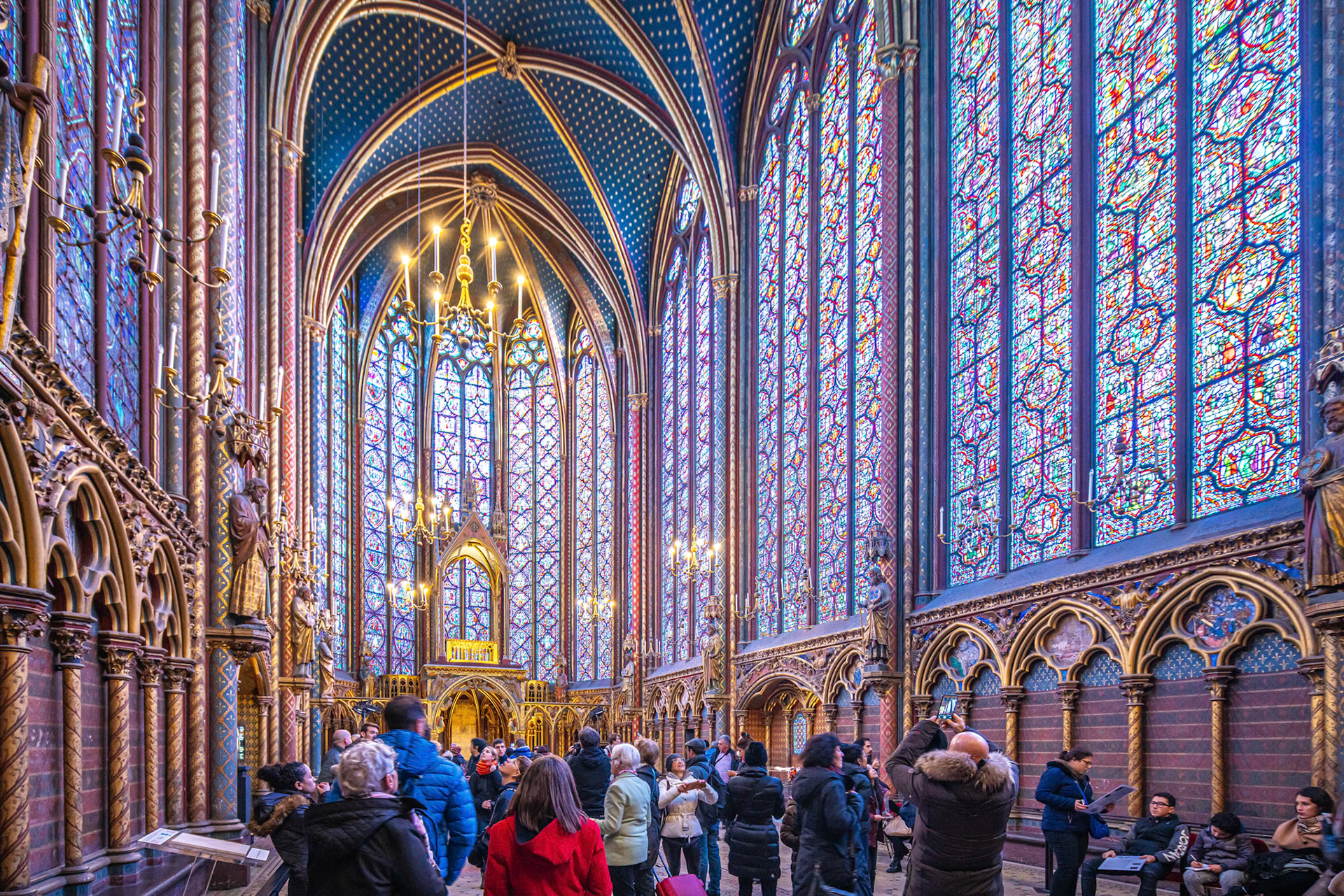 Tourists admire the stunning stained glass windows at the Sainte Chapelle.