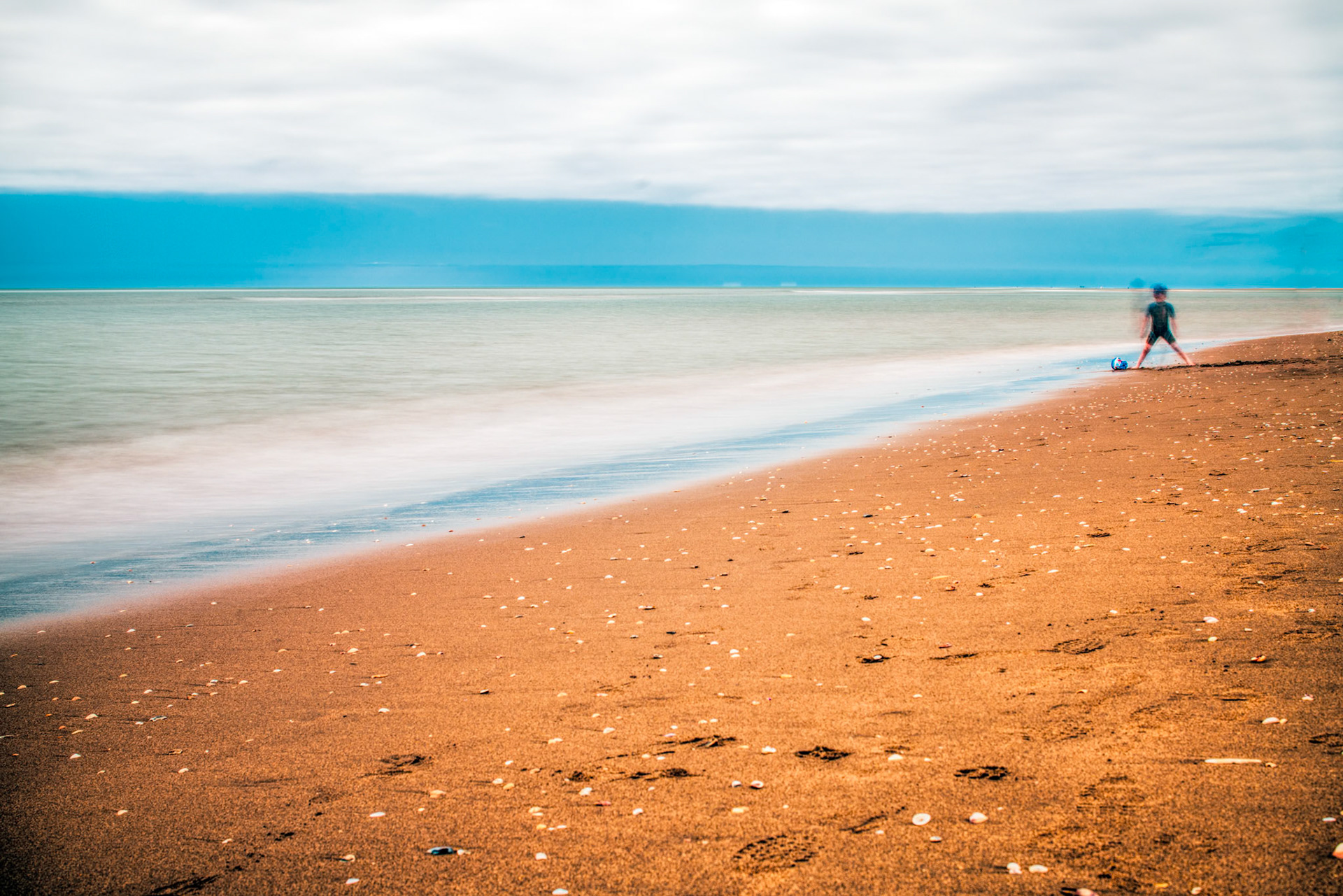 Kid on the beach, long exposure shot.