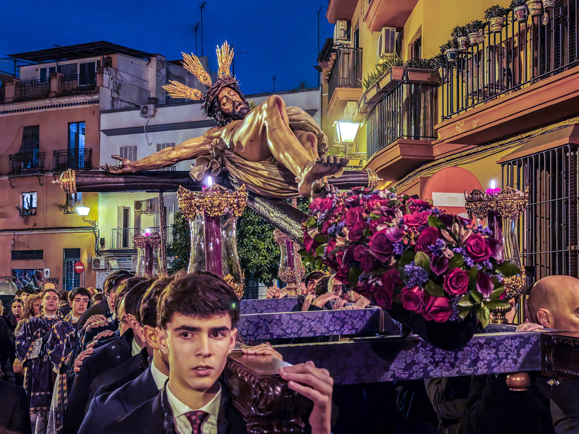 Nighttime Way of the Cross with the Christ of Buena Muerte (Good Death) by Hiniesta Brotherhood in Seville, Andalusia, Spain. Procession at dusk.