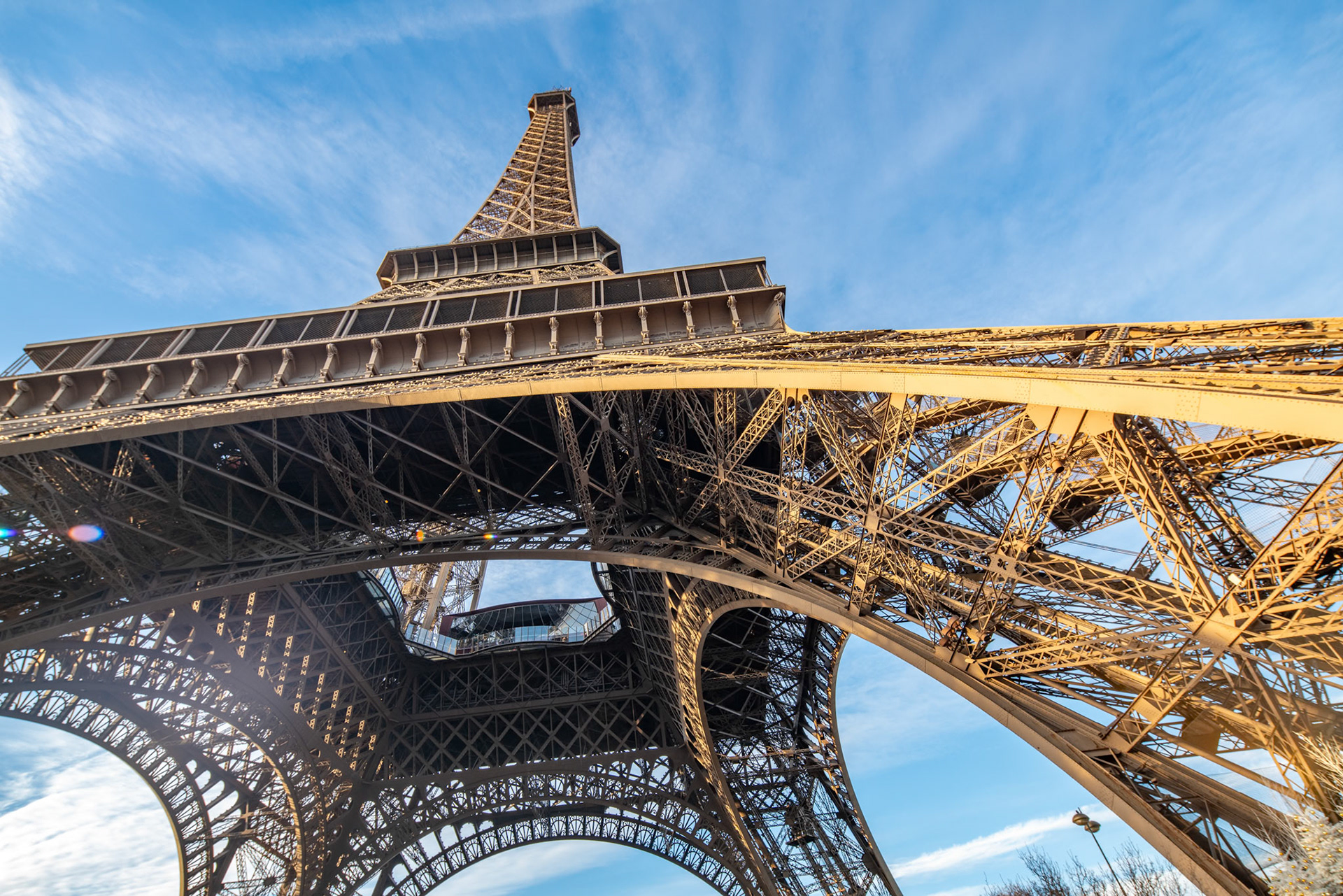 The Eiffel Tower stands tall against the blue sky in Paris.