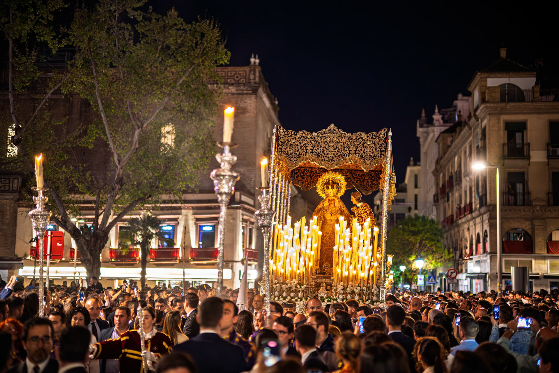 The Amargura processional float moves through a crowded Encarnacion Square on Palm Sunday night during Holy Week in Seville, Spain.