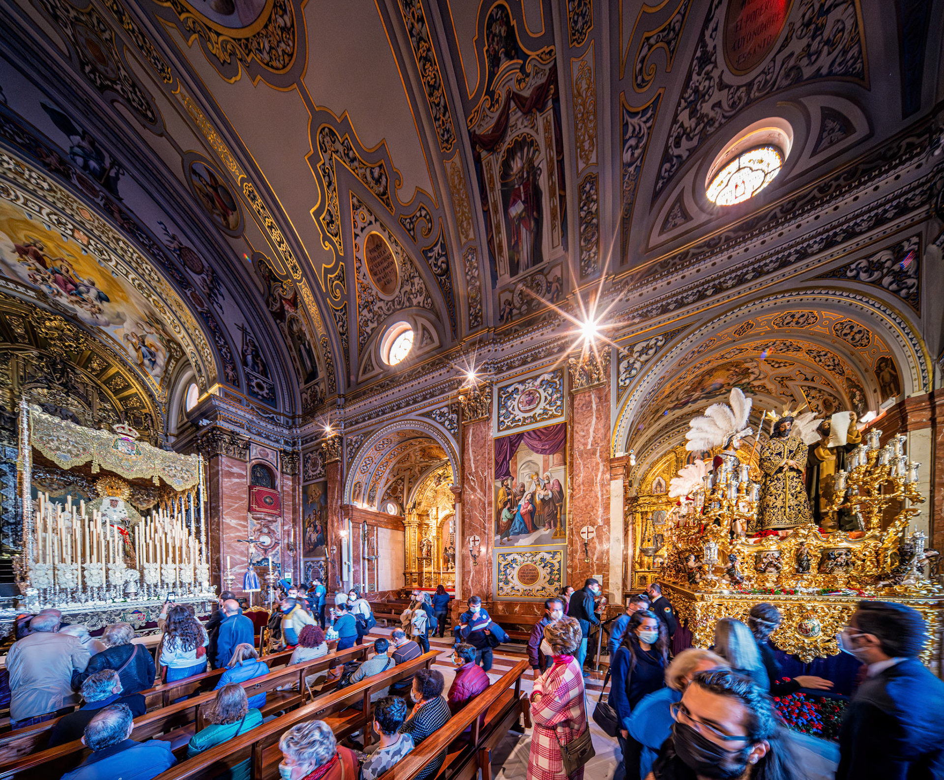 Faithful visit Esperanza Macarena palio float and Lord of la Sentencia mystery float in Macarena Basilica, Seville, days before Good Friday, Holy Week.