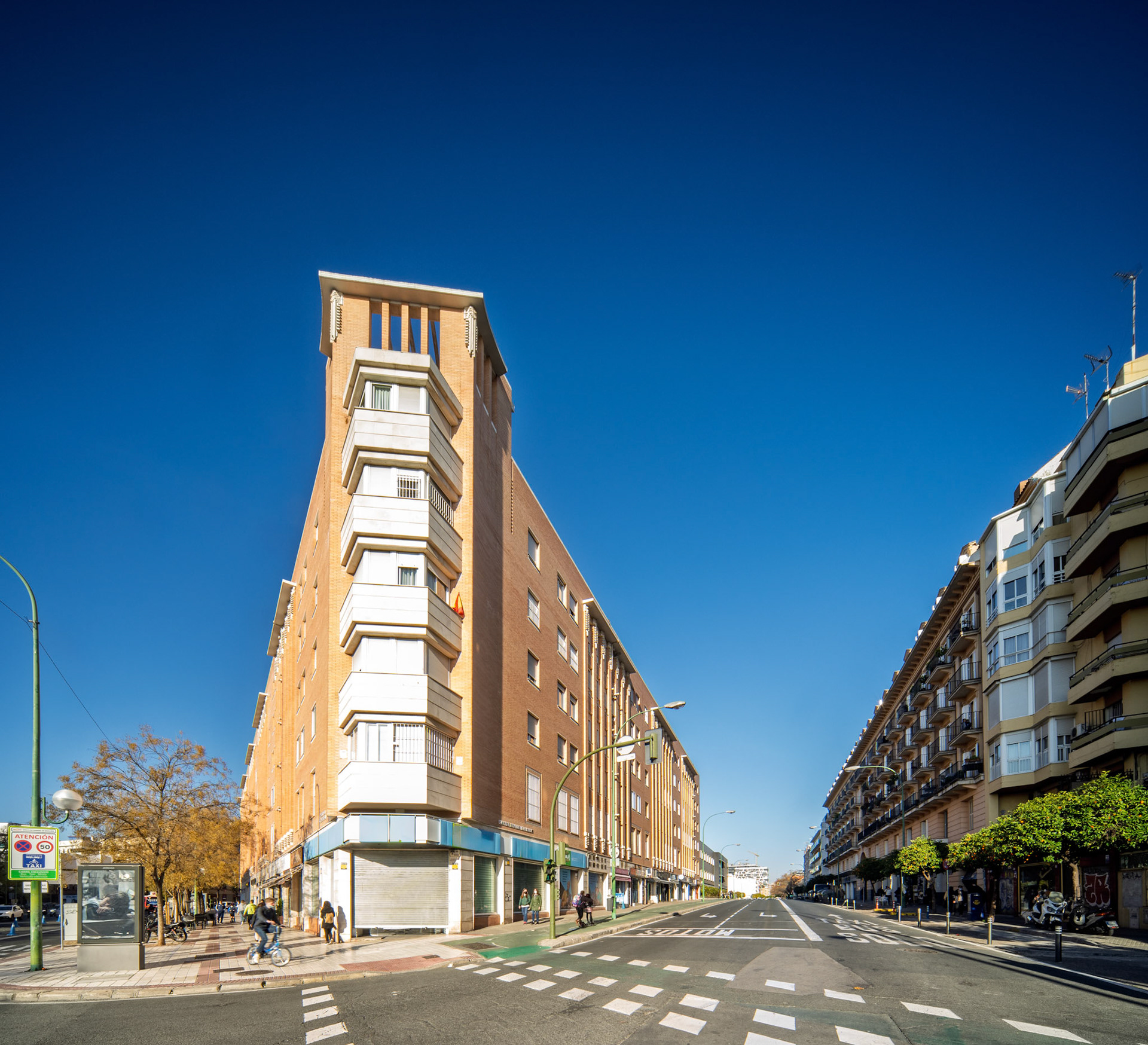 A striking modern residential building stands at the intersection of Carmona Road and Miraflores Avenue in Seville, showcasing unique architectural design.