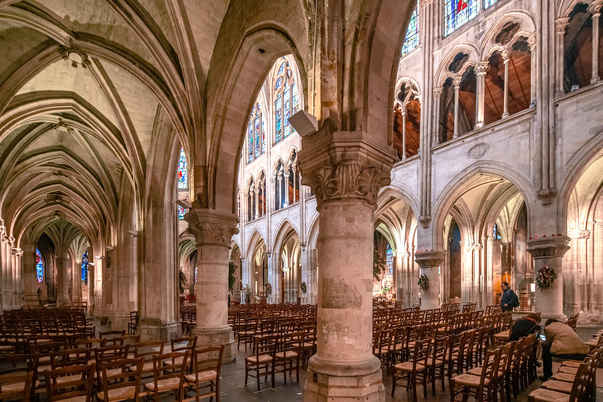 Vaulted ceilings and stained glass windows adorning the tranquil Saint Severin Church in Paris.