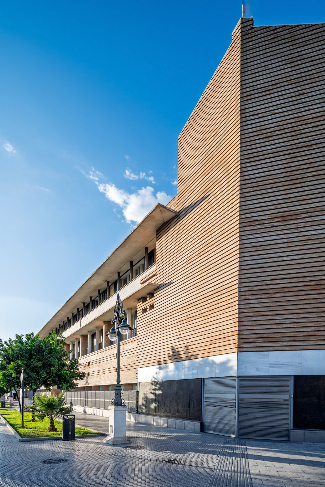 Building for Previsión Española, completed in 1987 by Rafael Moneo—horizontal brick and wood volumes echo Sevillian palatial rhythms with modern restraint