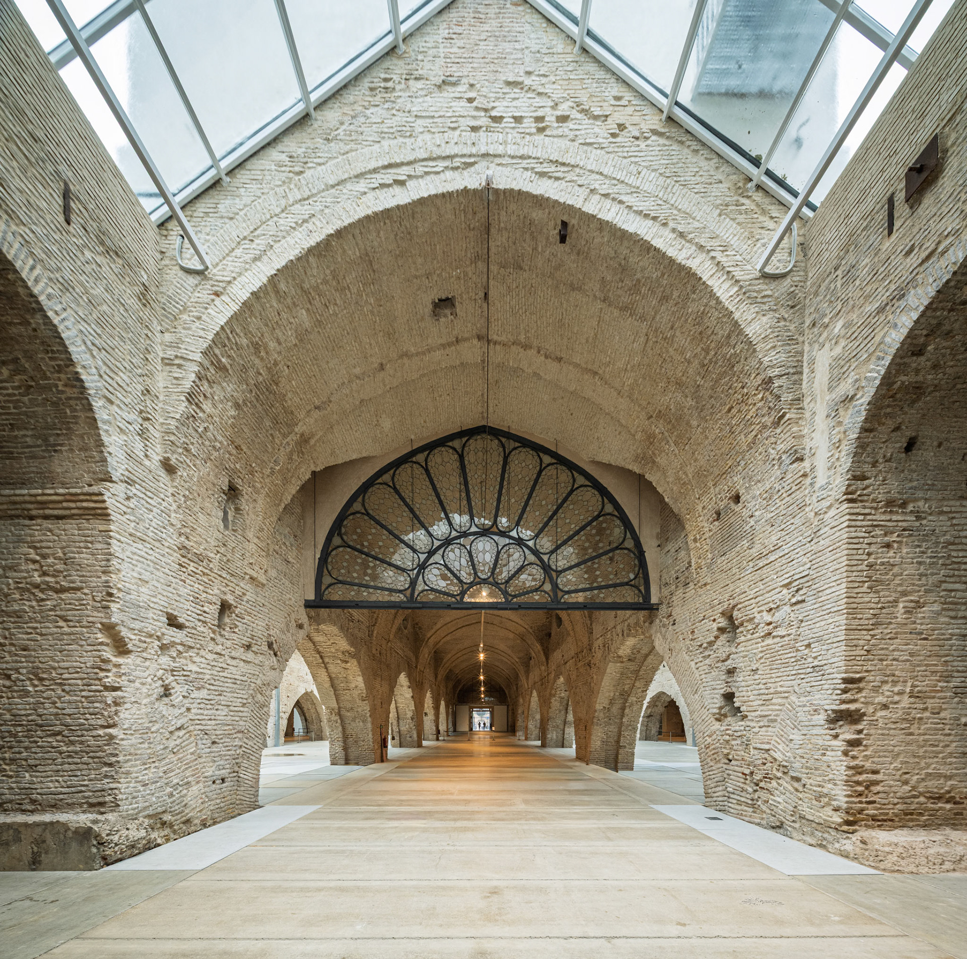 Atarazanas in Seville showcases medieval brick arches under a glass roof, creating a unique atmosphere.