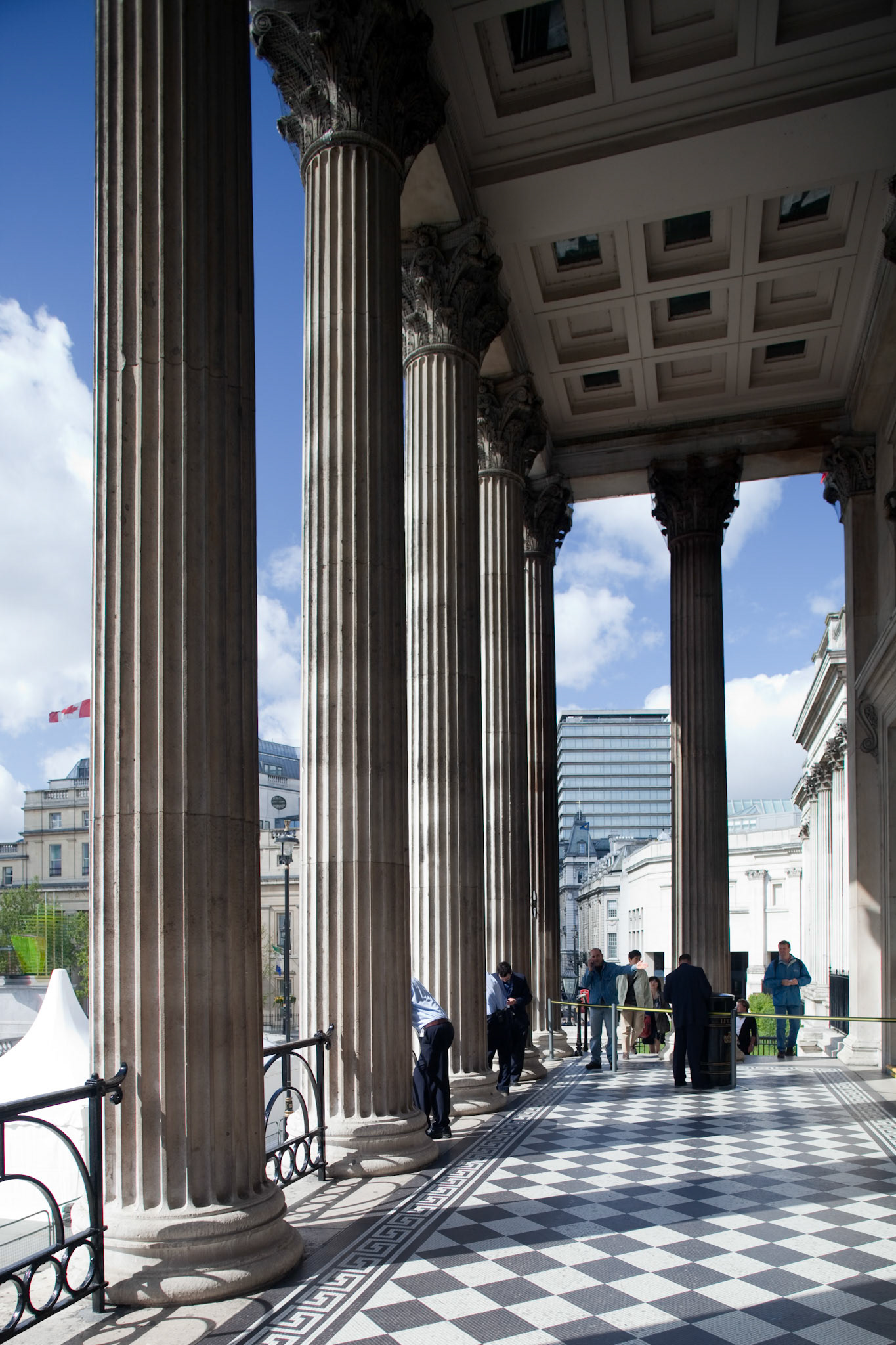London, UK, May 3 2009, People admire the impressive columns at the National Gallerys entrance on Trafalgar Square in London, enjoying a bright day.