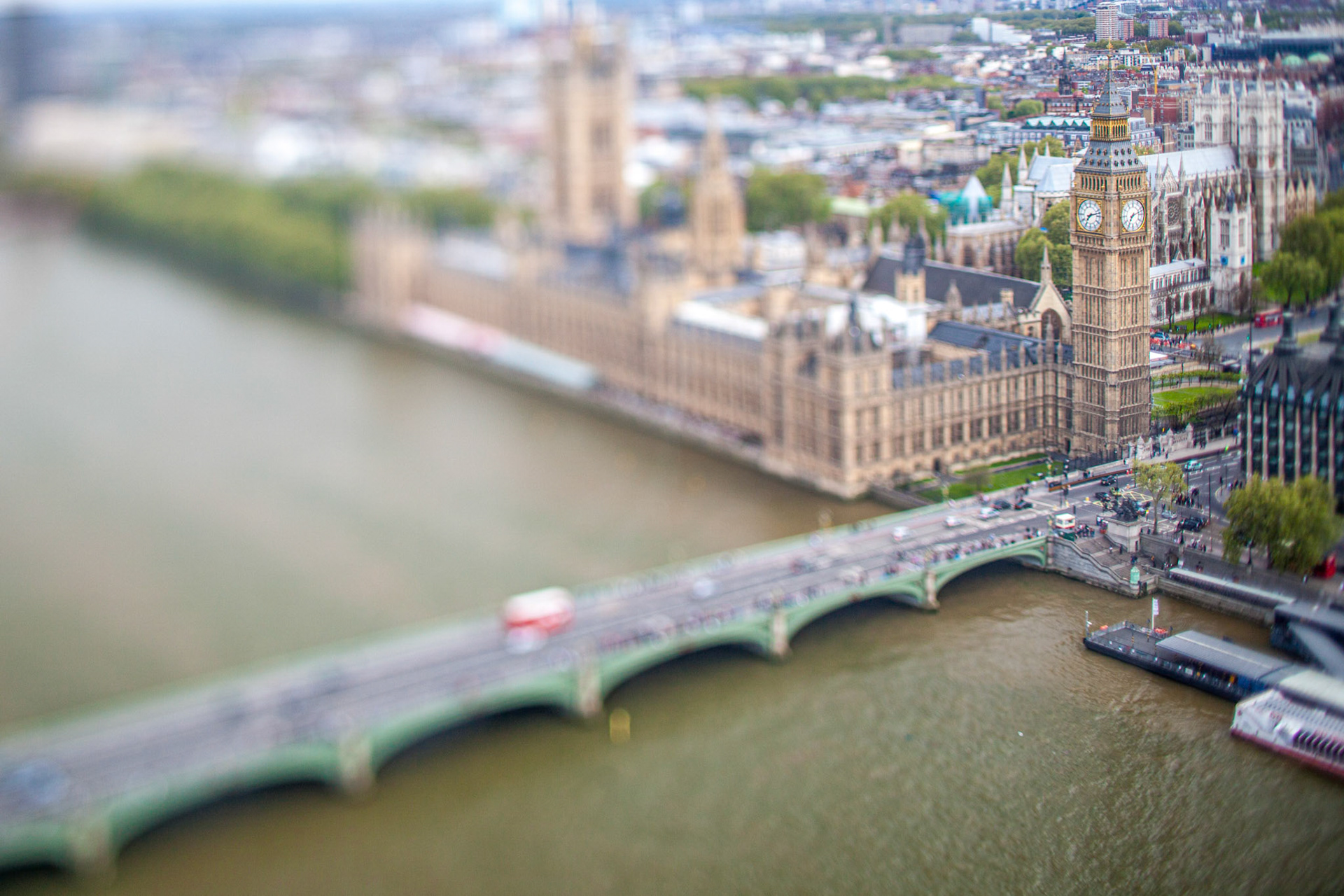 Westminster skyline with the Thames River in London, captured at dusk using a tilt-shift effect.