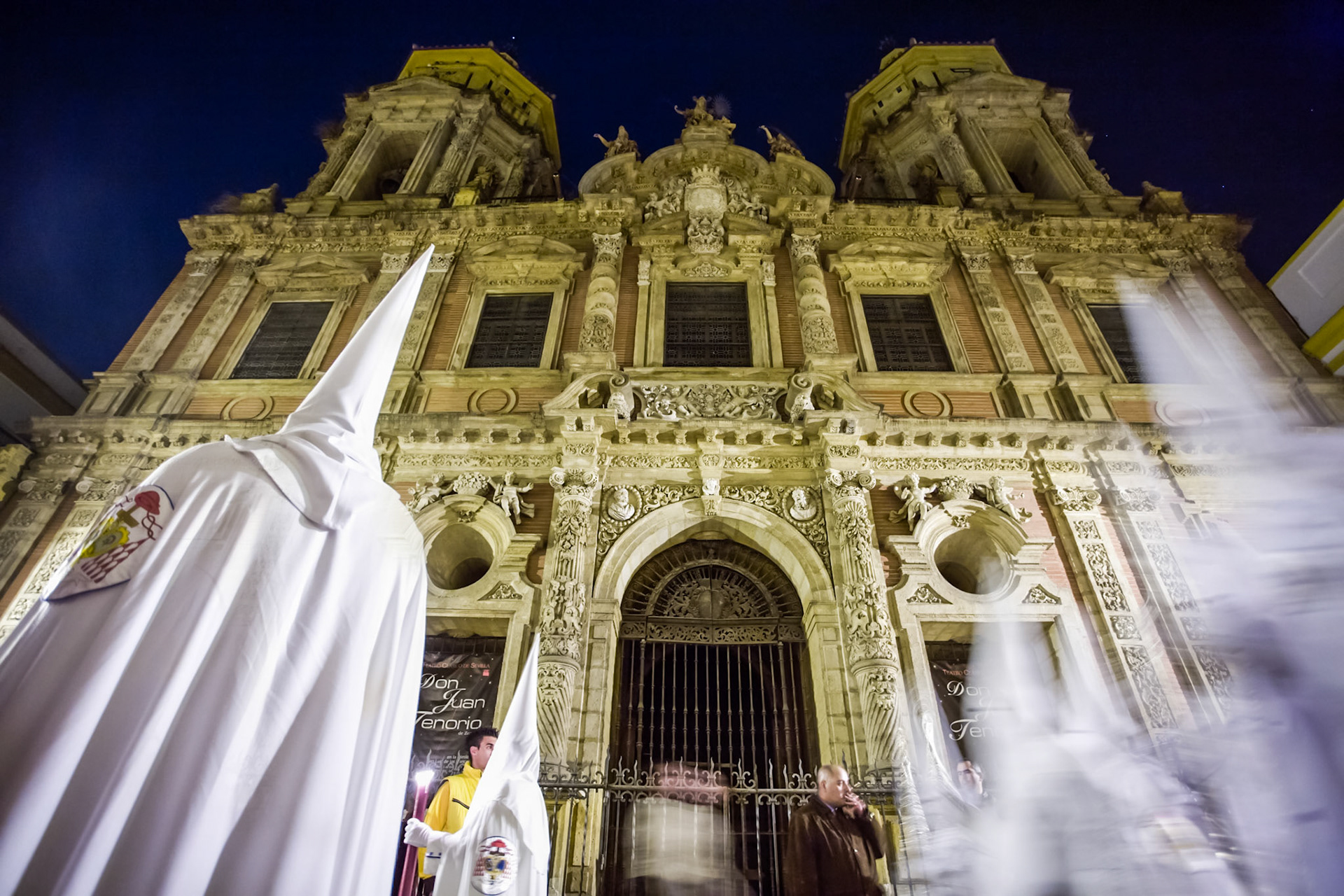 Hooded penitents in front of San Luis church, Holy Week, Seville, Spain