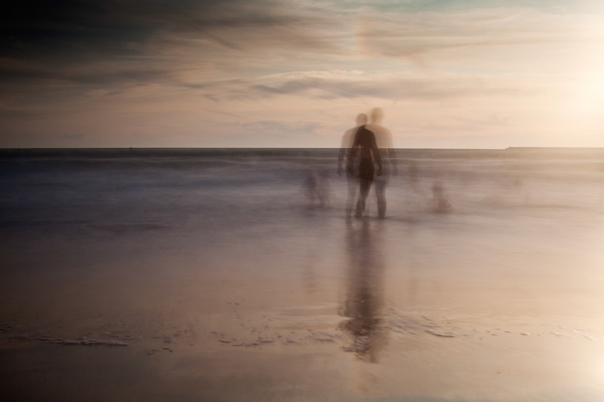 People bathing on the sea, Valdelagrana  beach, El Puerto de Santa Maria, Spain. Daylight long exposure shot by the use of neutral density filters.