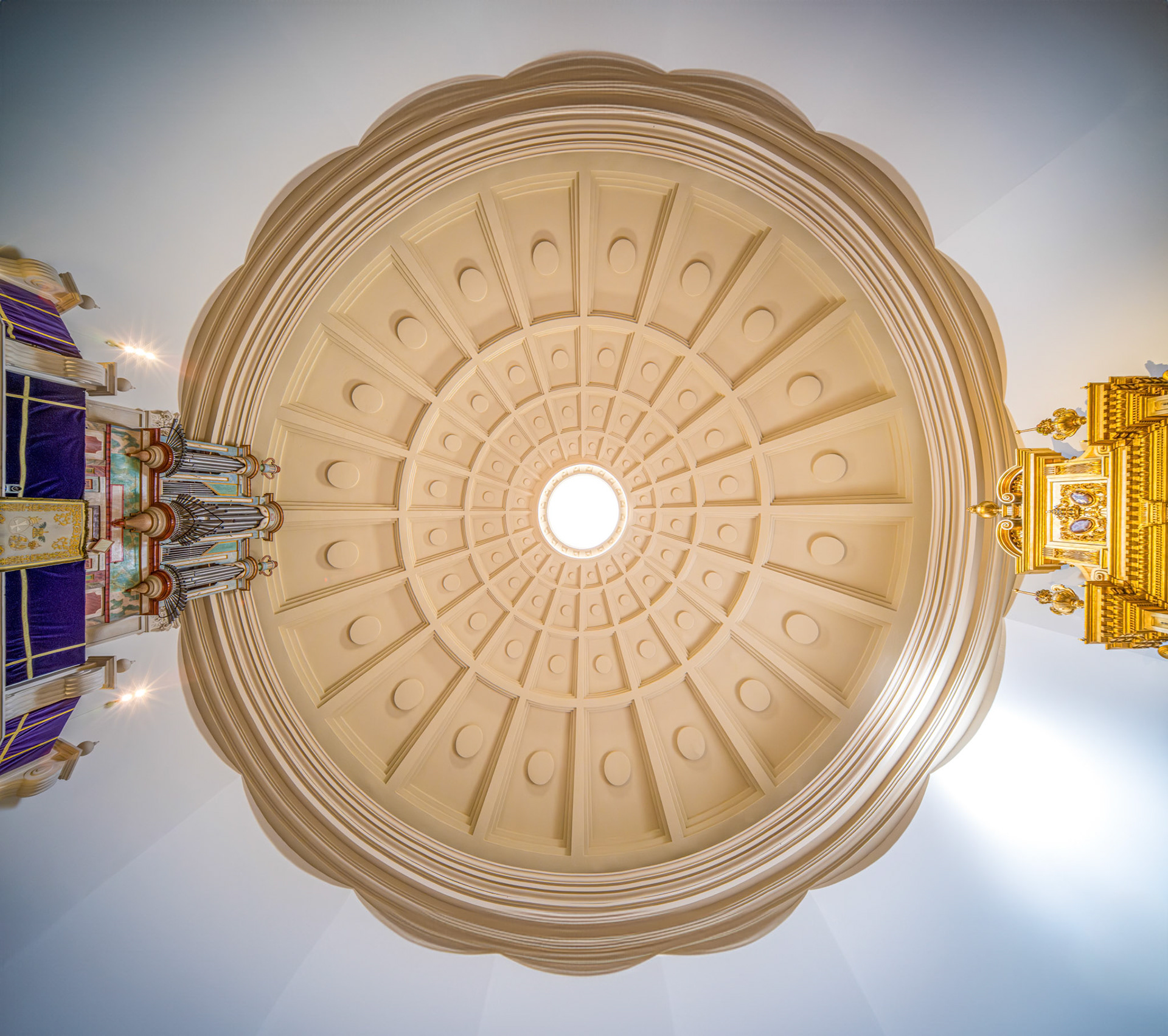Discover the stunning coffered dome of Basílica del Gran Poder in Seville. Its symmetrical design highlights the oculus and classical architecture.