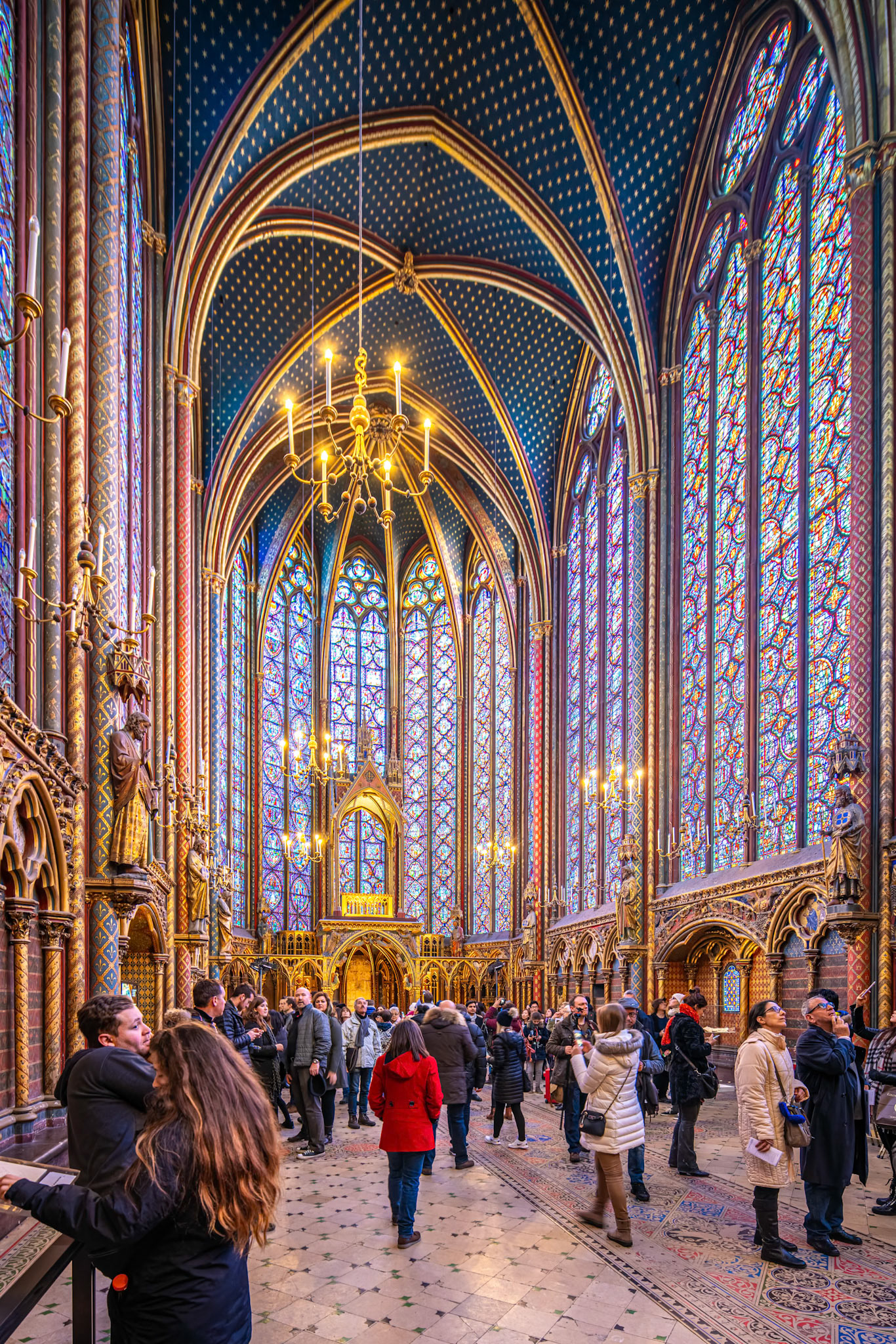 Tourists admire the stunning stained glass windows at the Sainte Chapelle.