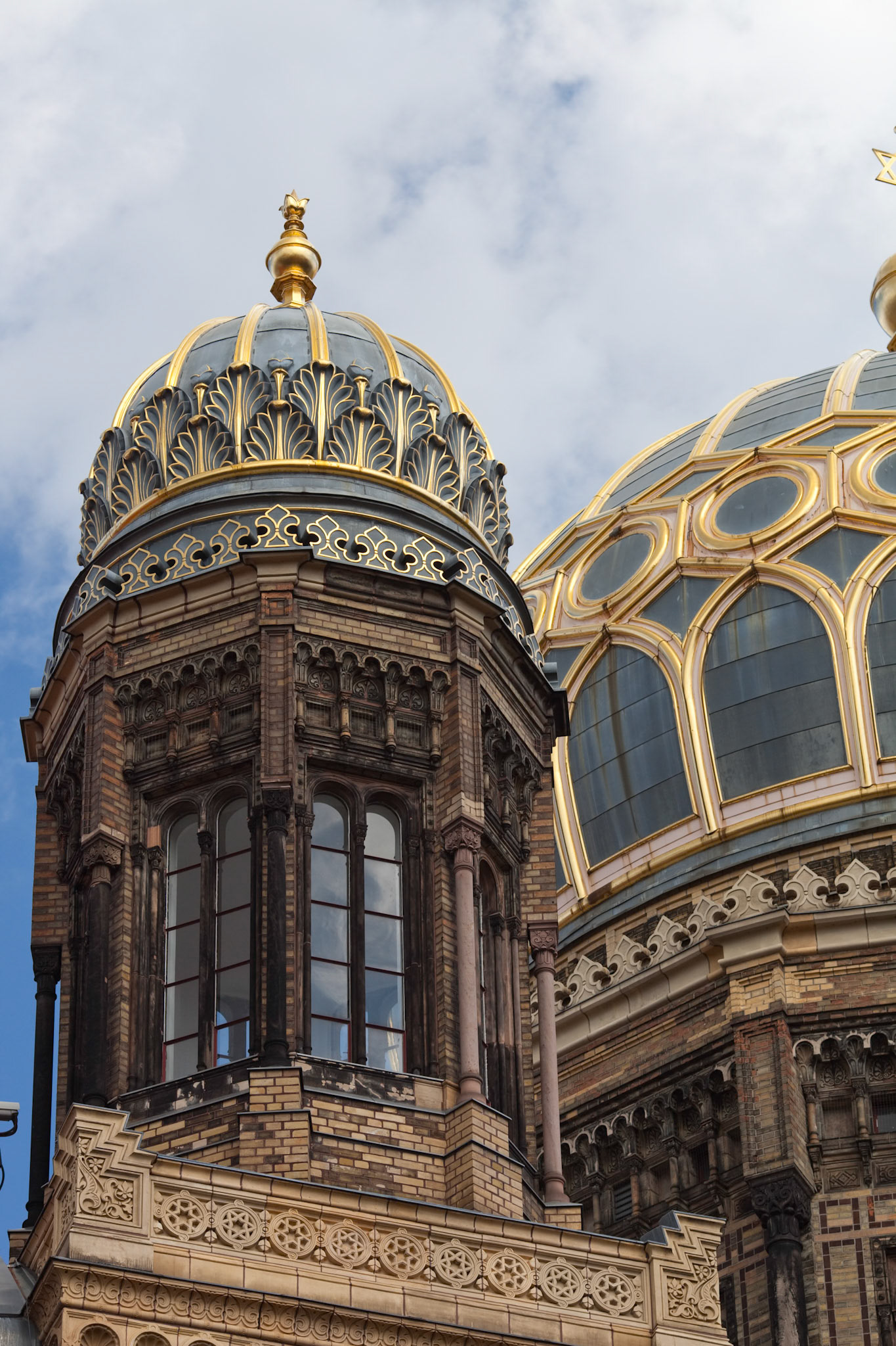 The ornate cupola of the New Synagogue in Berlin showcases stunning Moorish architectural details and a rich cultural history.