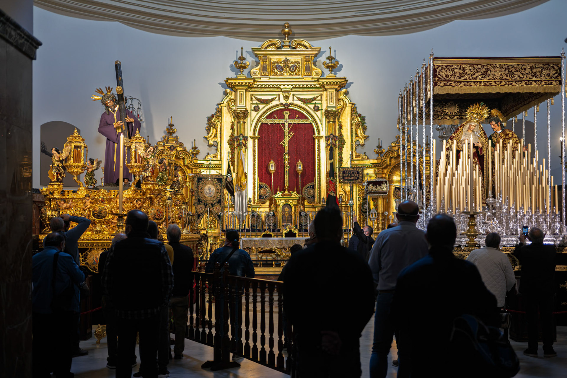 Faithful visit Gran Poder and Virgen del Mayor Dolor floats inside Gran Poder Basilica. Prepared for Good Friday dawn procession, Holy Week, Seville, Andalusia, Spain.