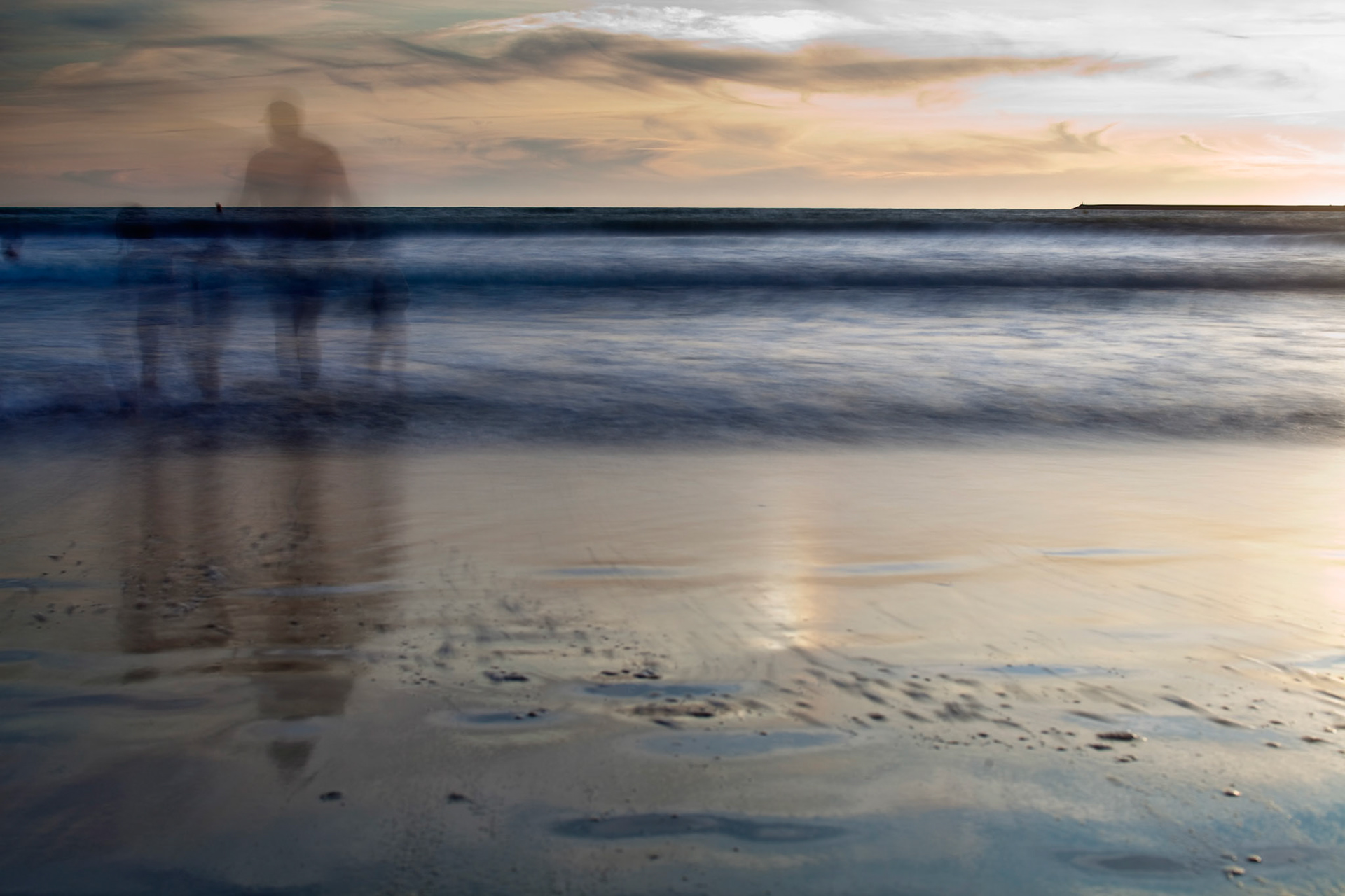 People bathing on the sea, Valdelagrana  beach, El Puerto de Santa Maria, Spain. Daylight long exposure shot by the use of neutral density filters.