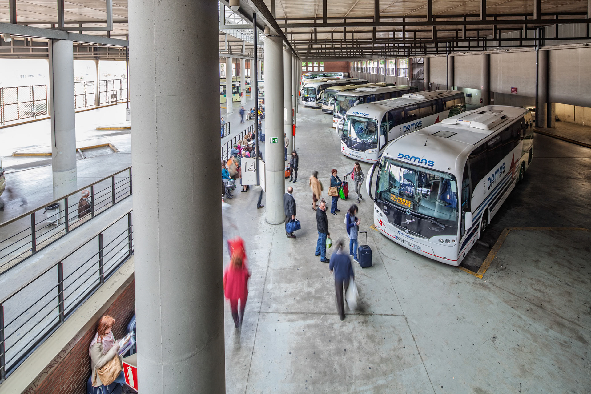 Seville, Spain, Nov 27 2019, Moments before boarding, travelers stand still in anticipation at Plaza de Armas, surrounded by buses awaiting their night journeys.