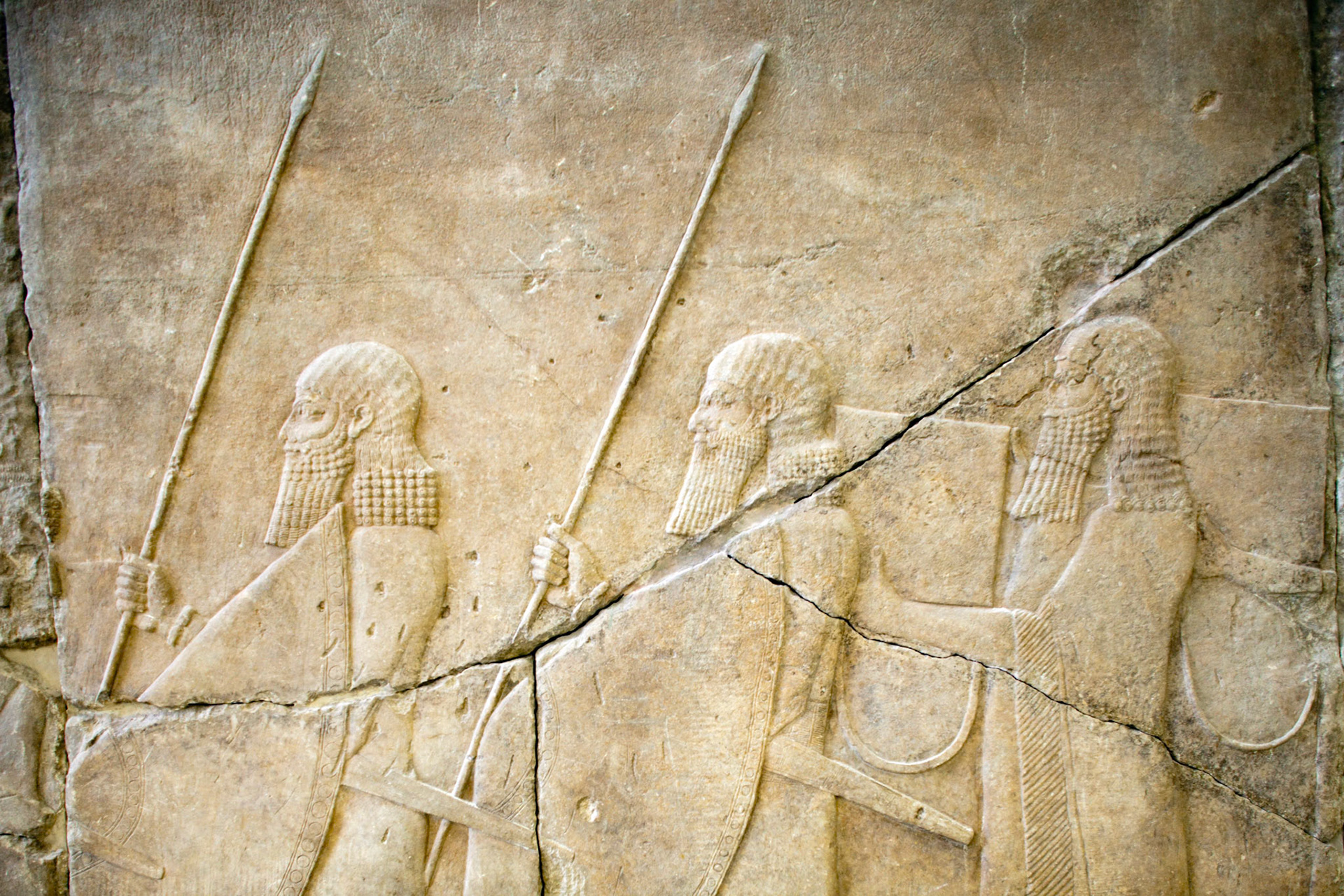 Berlin, Germany, July 24 2009, Explore the intricate Assyrian relief featuring ancient warriors at the Pergamon Museum in Berlin, showcasing a rich historical narrative.