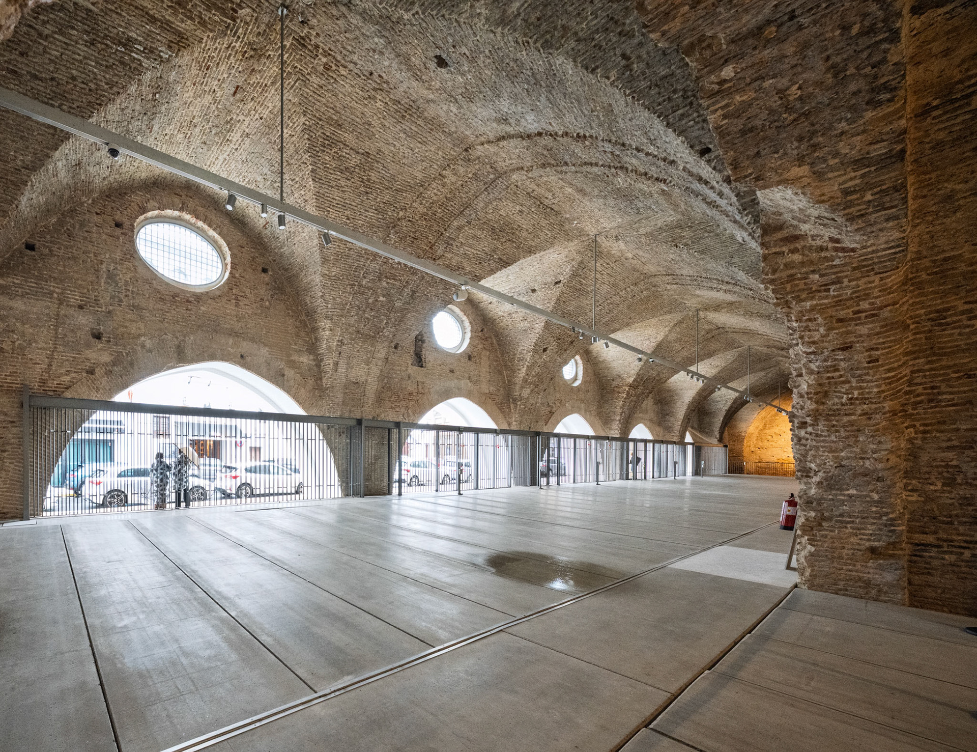 Seville's Atarazanas features historic brick vaults and circular windows.