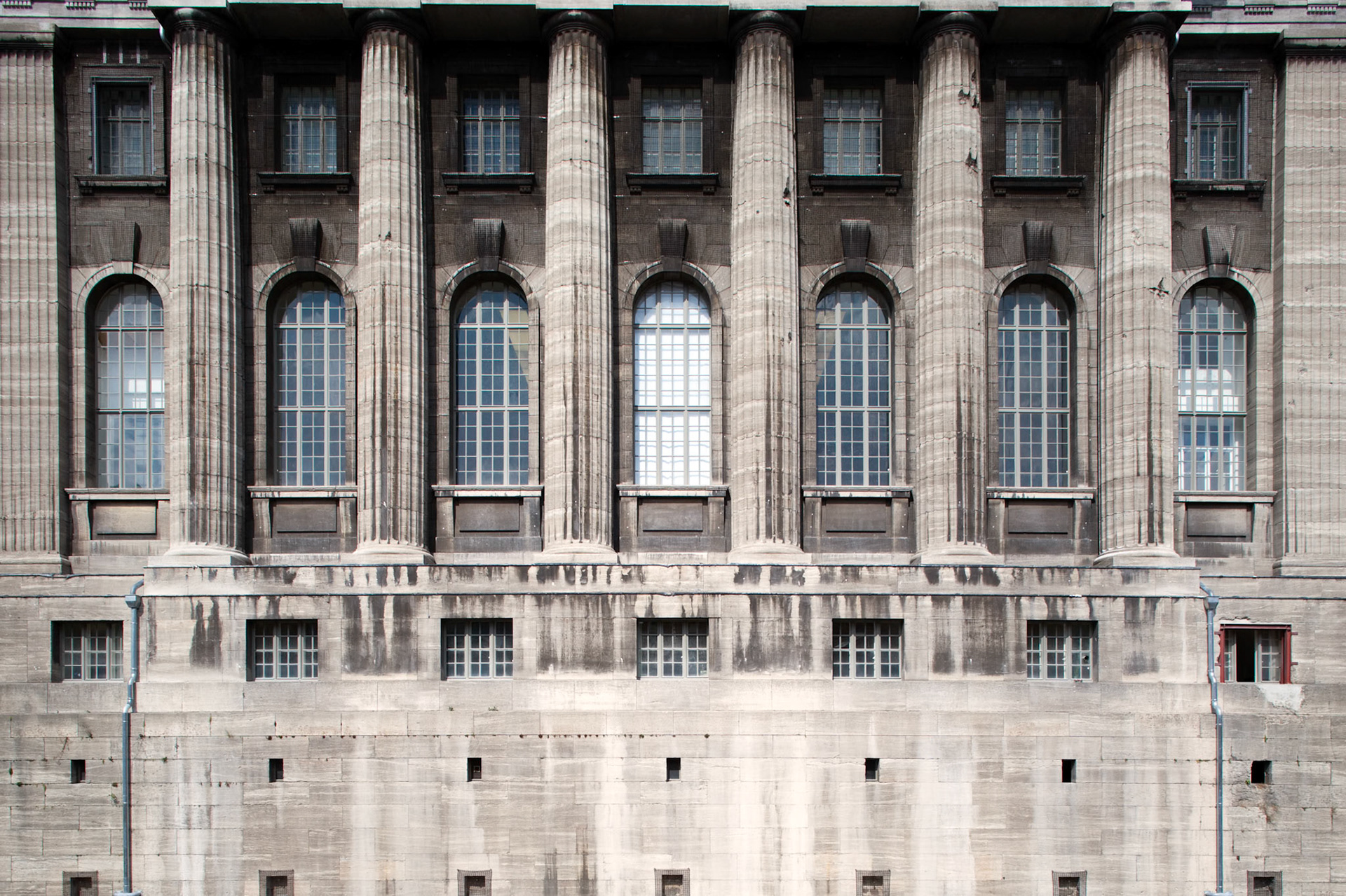 The Pergamon Museum in Berlin features a stunning architectural façade with grand columns and intricate window designs.
