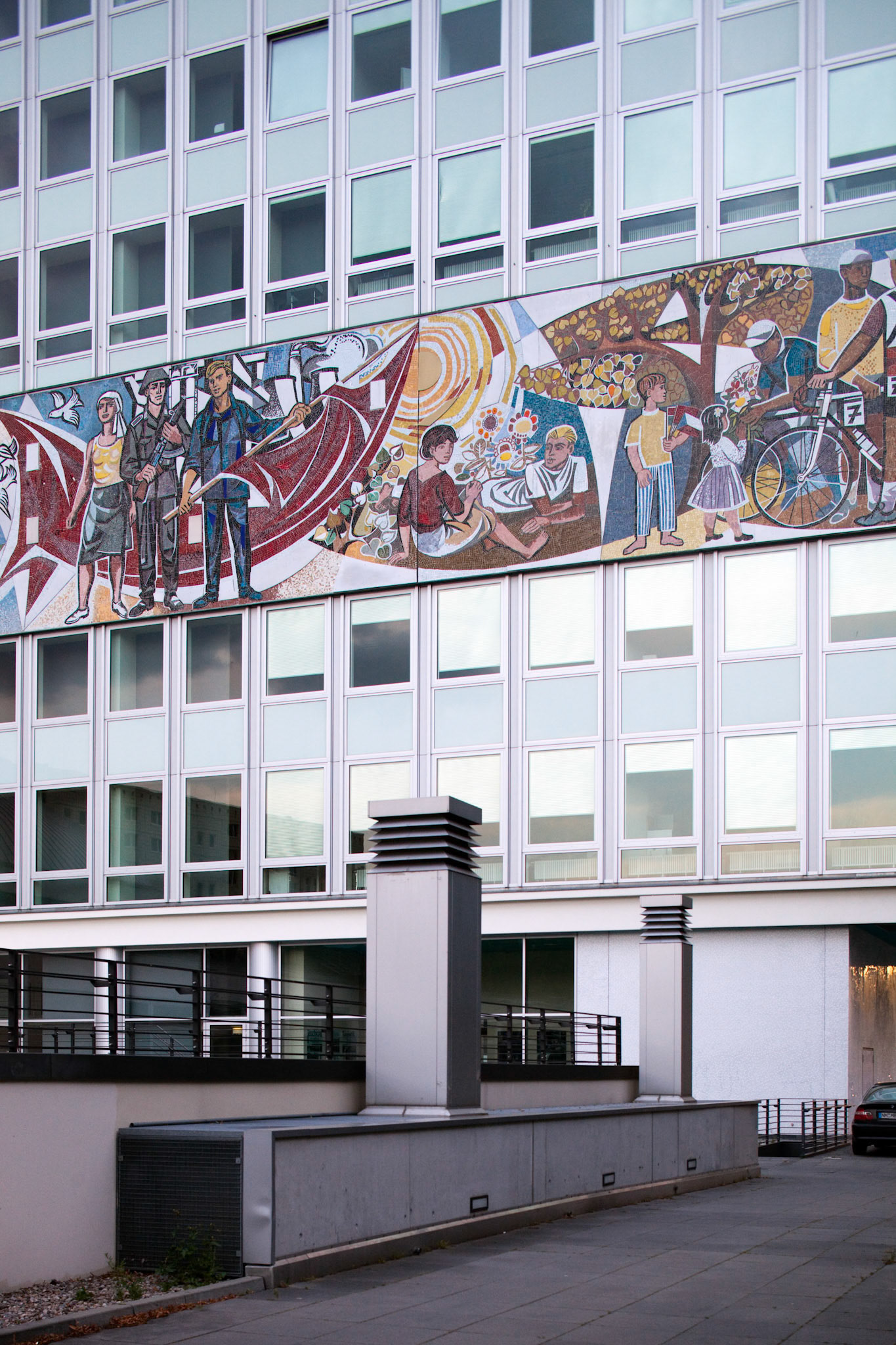 The Haus des Lehrers displays a vibrant Socialist mural depicting everyday life and community activities in Berlin.