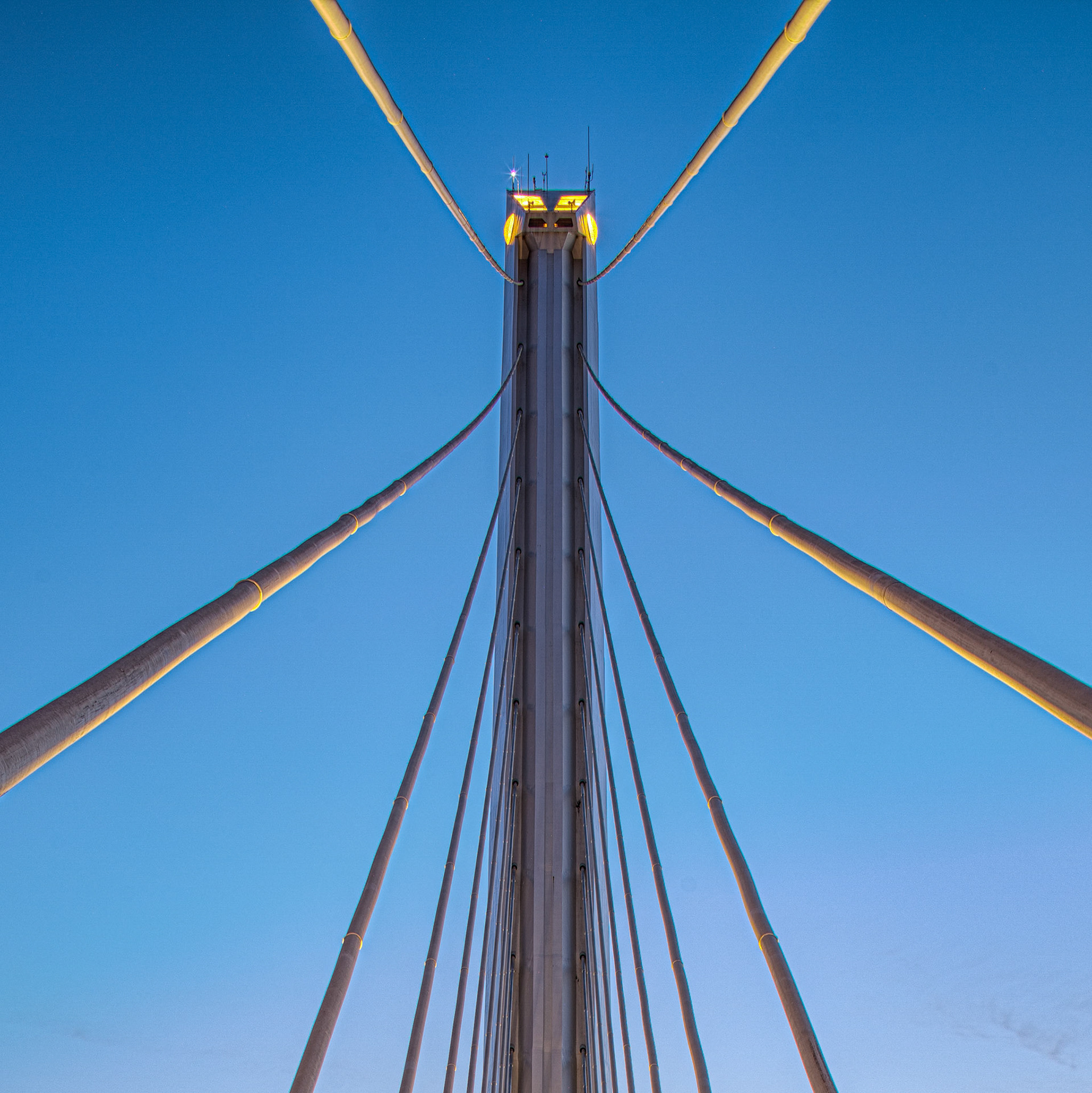Seville's Alamillo Bridge, with its harp-like design, soars into the sunset, showcasing stunning engineering and art.