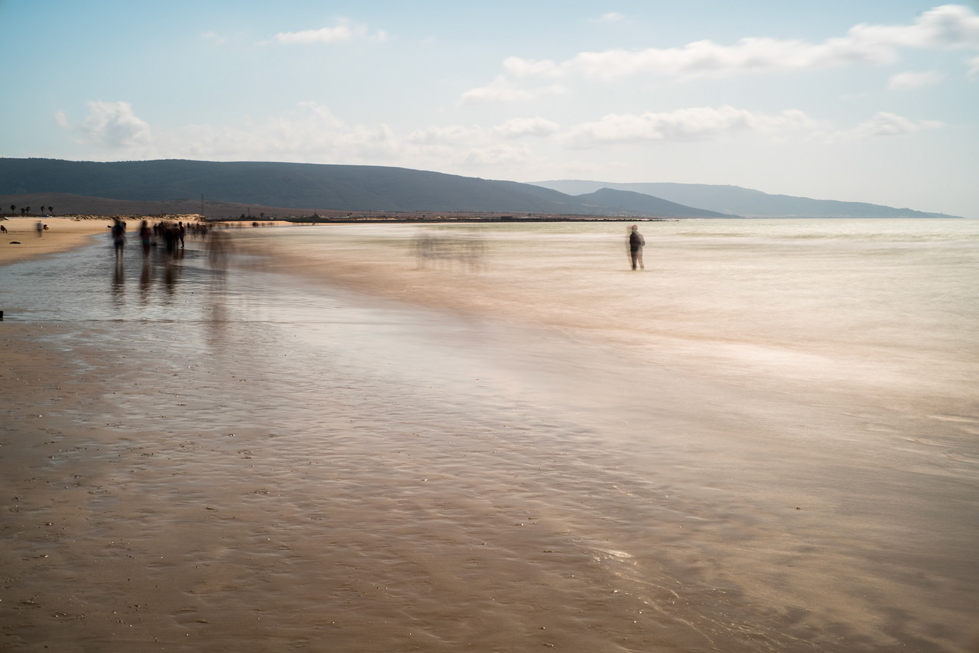 Ghostly people on a beach, long exposure shot, Playa del Carmen, Barbate, Andalusia, Spain.