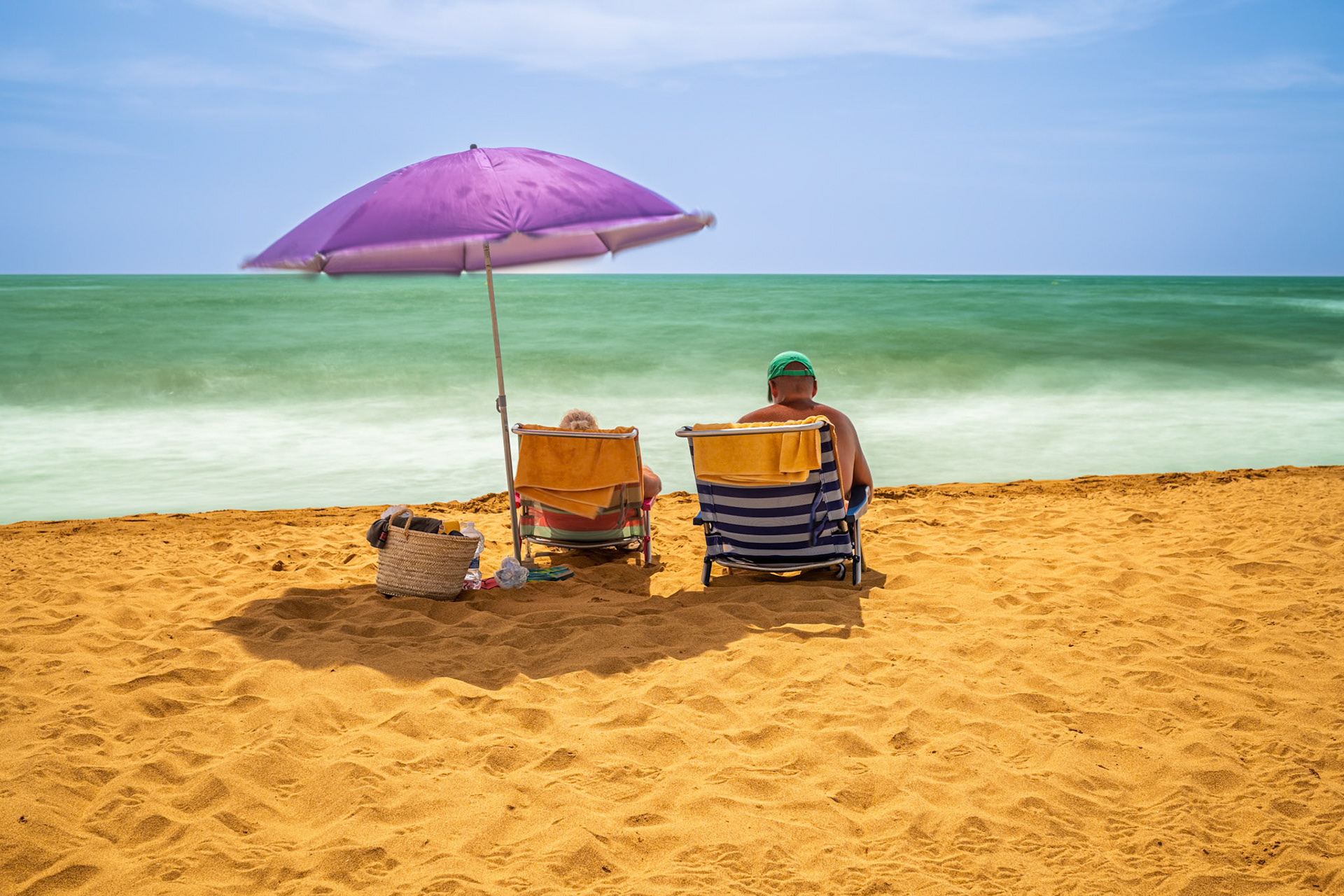Enjoying a peaceful day at Isla Canela beach in Ayamonte, a long exposure captures the calm waters and golden sand on a sunny afternoon.