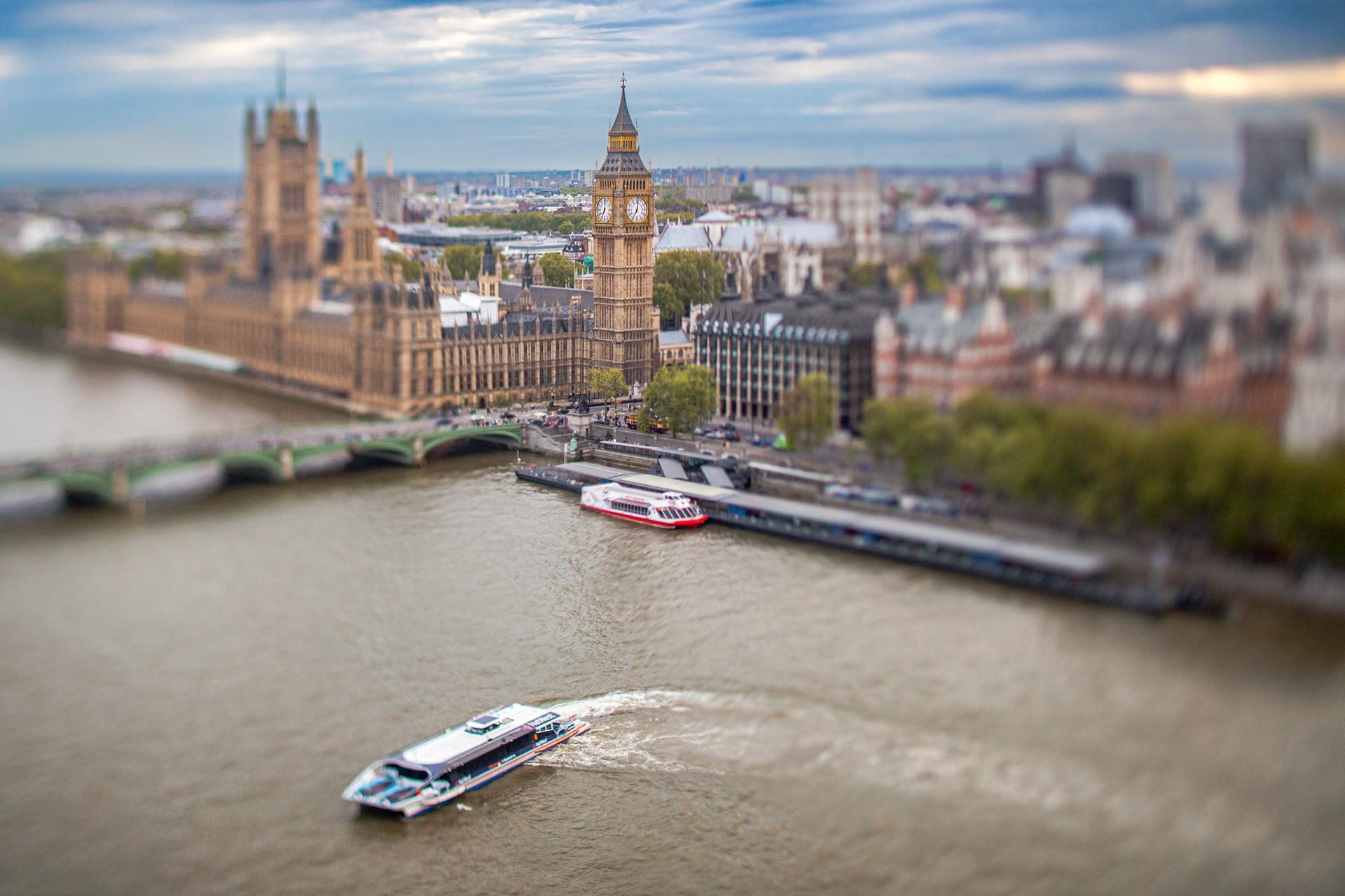 Westminster skyline with the Thames River in London, captured at dusk using a tilt-shift effect.