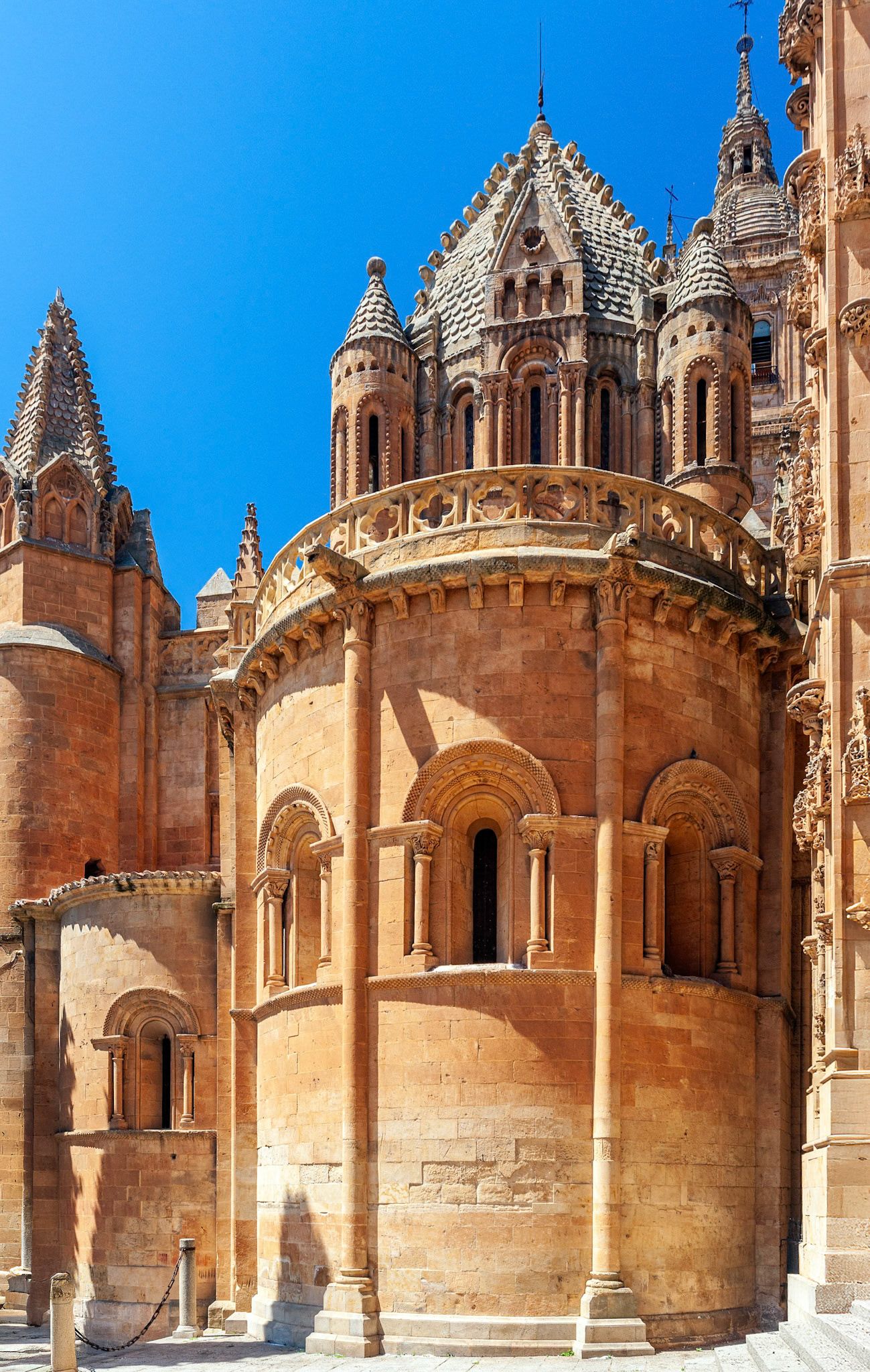 Romanesque Old Cathedral in Salamanca, Spain, against a bright blue sky.