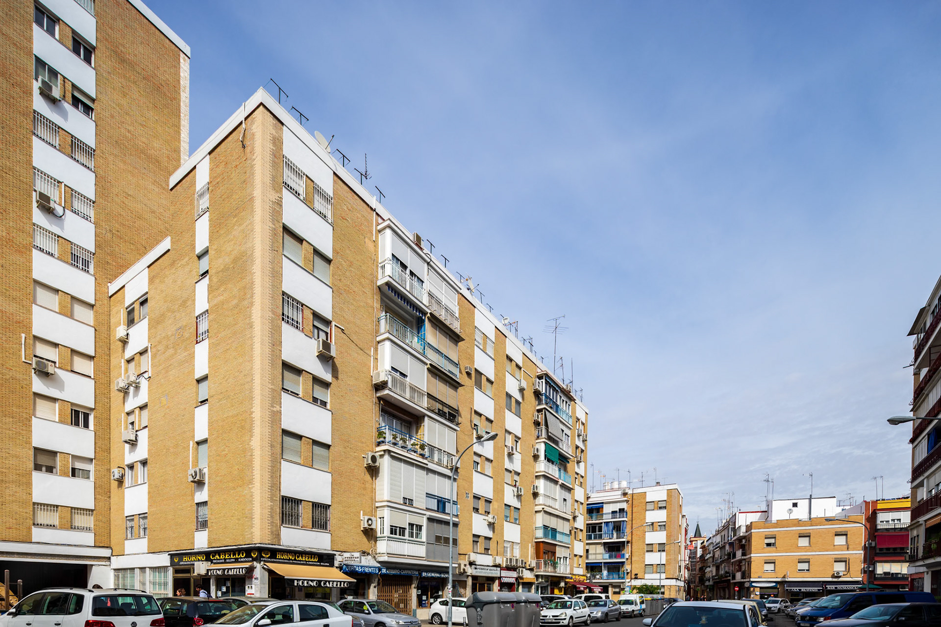 Urban architecture showcasing residential buildings in the historic Triana district of Seville.