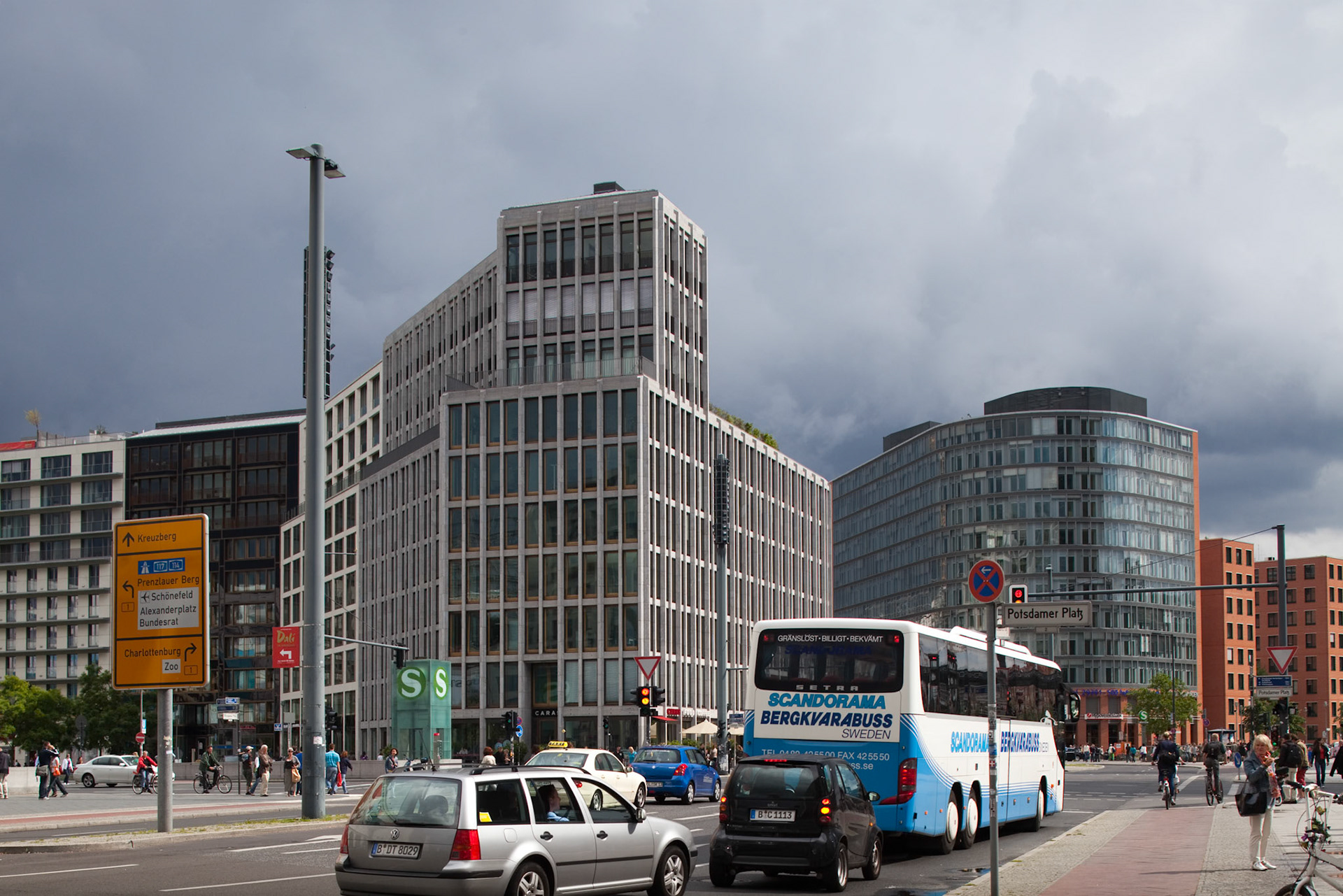 Berlin, Germany, July 24 2009, Potsdamer Platz features contemporary buildings with busy streets filled with cars and buses under a cloudy sky in Berlin.