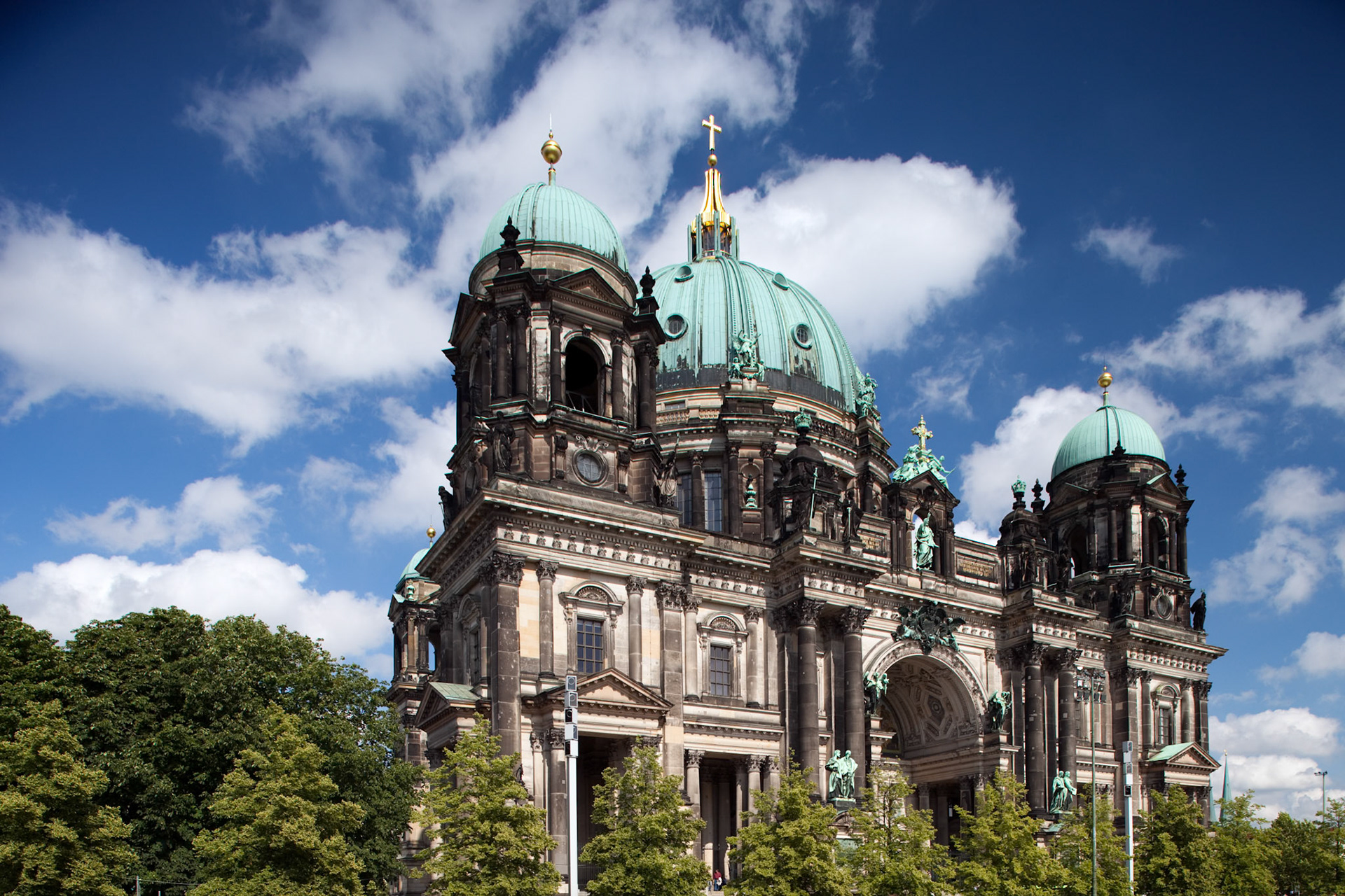 The iconic Berliner Dom showcases its impressive architecture against a vibrant sky in Berlin, drawing visitors to its historic grandeur.