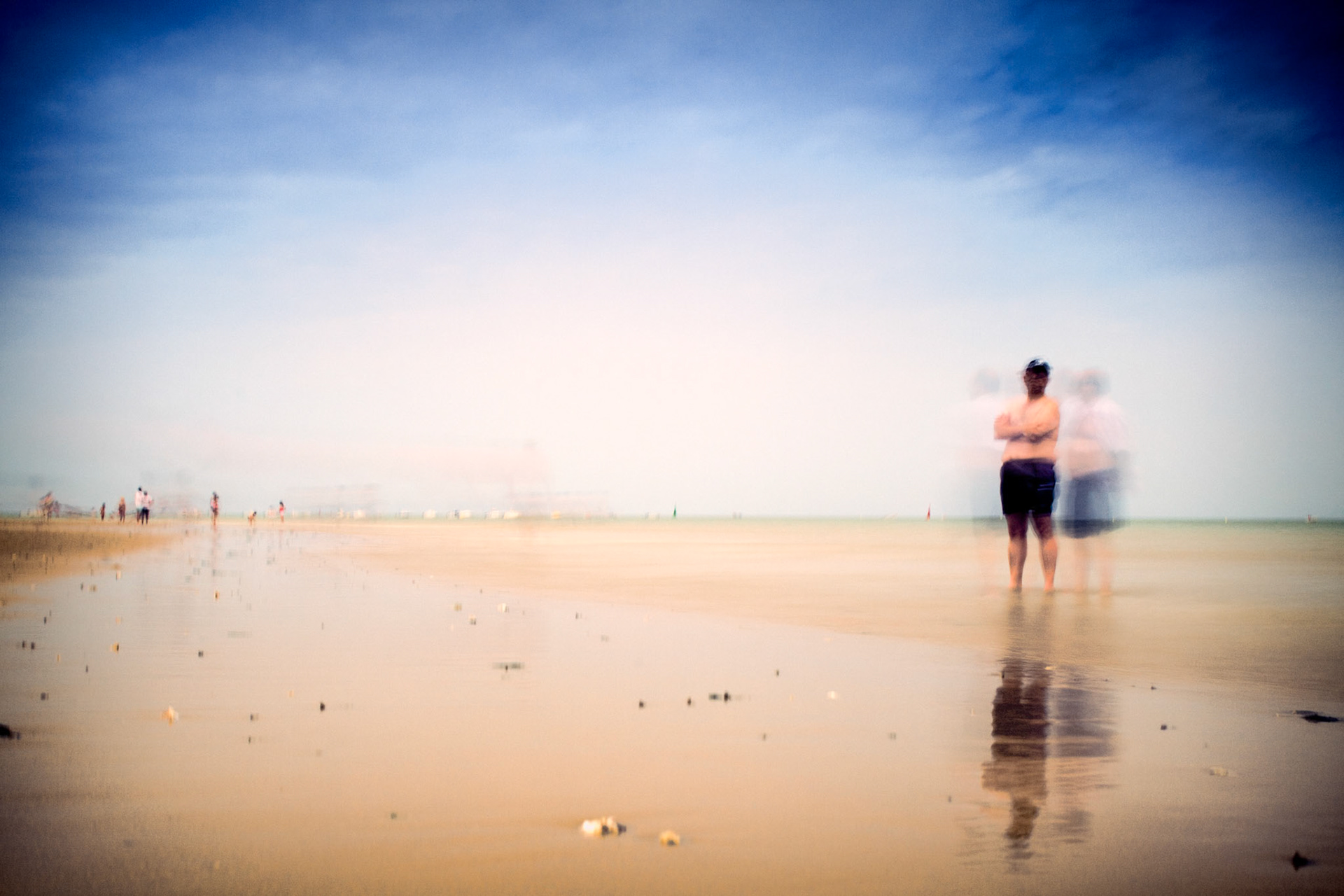 People on the beach, Sanlucar de Barrameda, Spain. Daylight long exposure shot by the use of neutral density filters.