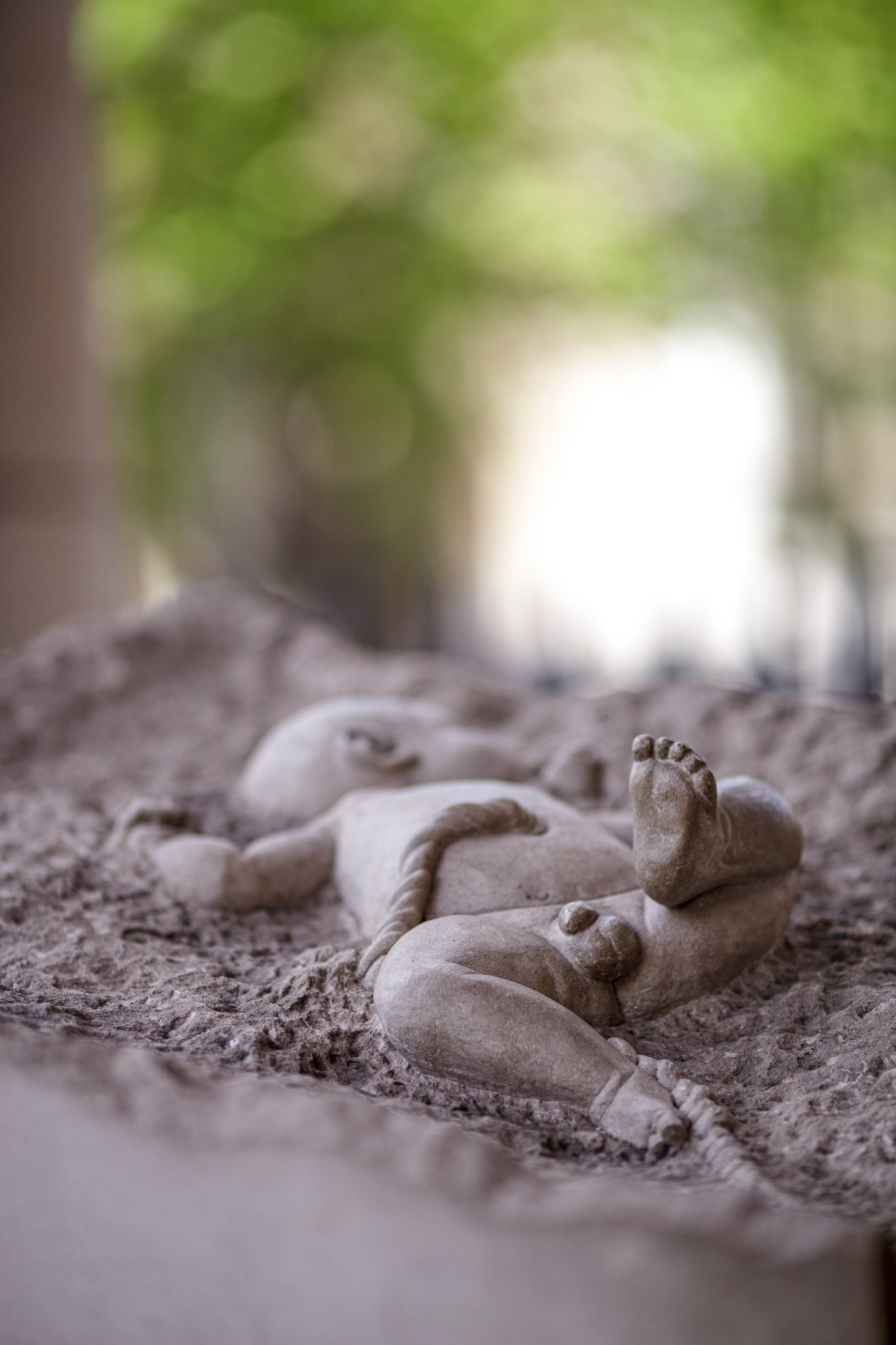 A sculpture of a newborn Jesus is placed at the entrance of Saint Martin in the Fields church in London, showing details of the figure and surroundings.