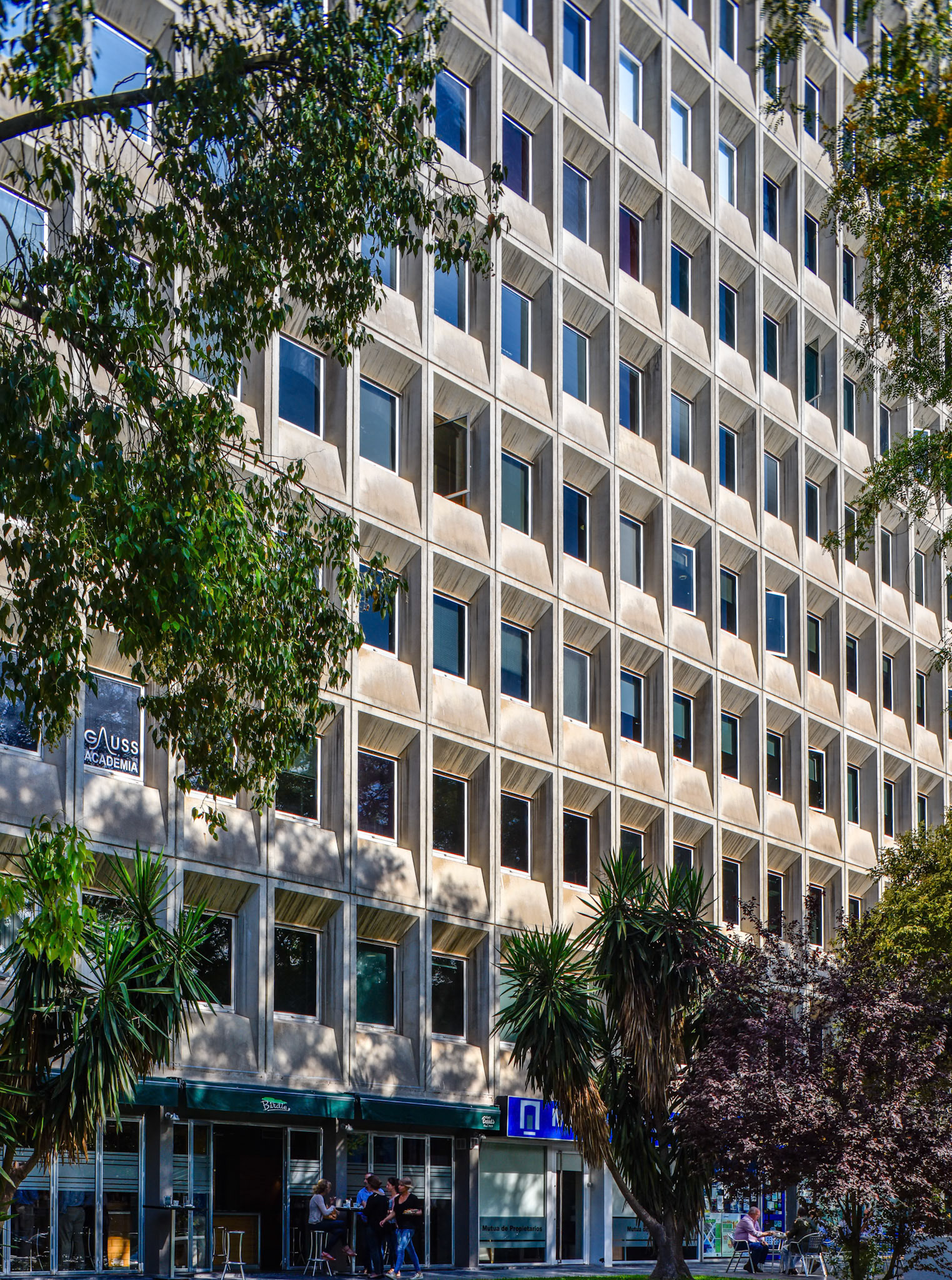 A detailed view of Edificio Sevilla 1 in Seville, Andalusia, Spain, showcasing its rationalist architectural style from 1972.